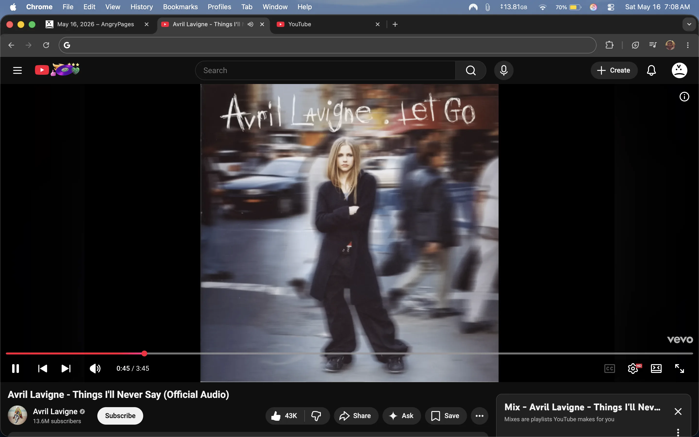 1) The image is a screenshot from YouTube featuring the official audio of "Things I'll Never Say" by Avril Lavigne. In the foreground, a young woman with long, straight blonde hair stands confidently with her arms crossed, wearing a black oversized coat and baggy pants. The background is a busy urban scene that appears somewhat blurred, emphasizing the subject. Various figures in casual attire can be seen walking past, suggesting a lively street atmosphere. The color palette is muted, primarily featuring greys and blacks, with the title of the song and artist prominently displayed in a handwritten font at the top. The overall mood conveys a sense of youthful defiance and introspection, fitting the theme of Avril Lavigne's music. The layout includes standard YouTube controls at the bottom, enhancing the viewer's engagement with the audio content.
2)
- Title: "Avril Lavigne - Things I'll Never Say (Official Audio)"
- Channel / profile: "Avril Lavigne"
- Site / app: "YouTube"