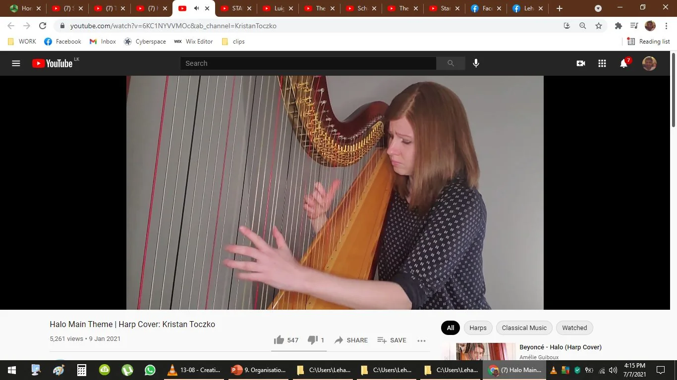 The image is a screenshot from a YouTube video titled "Halo Main Theme | Harp Cover: Kristan Toczko," published on the channel "Kristan Toczko." The video features a harpist performing a cover of the "Halo Main Theme." In the image, the harpist is focused intently on playing the harp, with a serious expression. The harp is prominently displayed, showing its strings and the intricate design of the instrument. The harpist wears a dark, polka-dotted shirt and appears to be in a well-lit indoor setting with a plain background, allowing the viewer to concentrate on the performance. The video has garnered 5,261 views since being uploaded on January 9, 2021. The interface shows typical YouTube elements like the view count, thumbs-up icon, and share options. Below, topic tags such as "Harps" and "Classical Music" are visible, indicating the video’s thematic focus.
- Title: "Halo Main Theme | Harp Cover: Kristan Toczko"
- Channel / profile: "Kristan Toczko"
- Site / app: "YouTube"