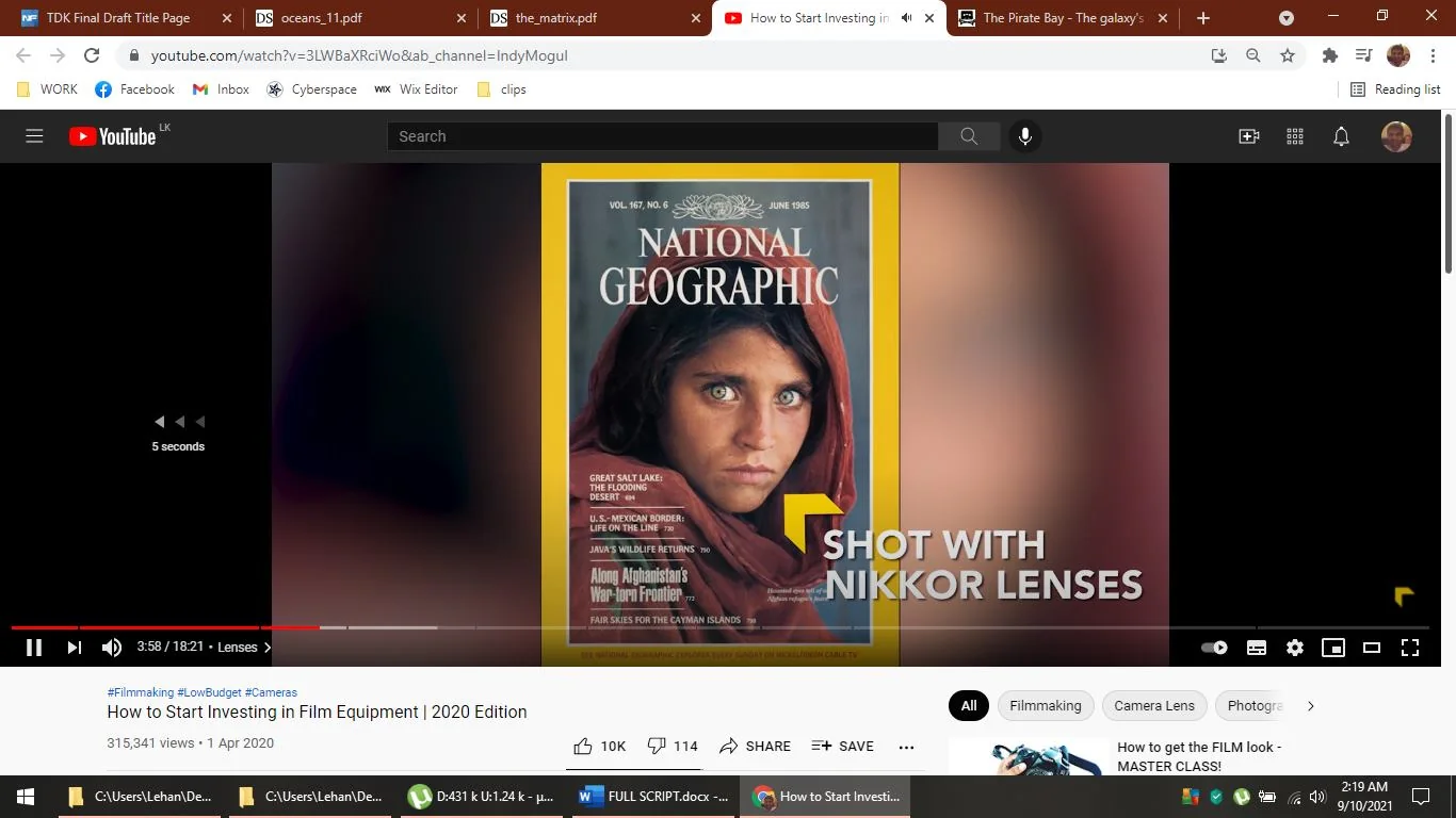 The image is a screenshot from a YouTube video titled "How to Start Investing in Film Equipment | 2020 Edition" by the channel Indy Mogul. The video appears to be a tutorial or informational guide on filmmaking equipment. The screenshot prominently features the iconic National Geographic magazine cover, recognizable by its yellow border. This particular cover is known for its striking photograph of a young girl with piercing eyes. The text overlay "SHOT WITH NIKKOR LENSES" suggests a discussion about the types of lenses used in photography, specifically highlighting Nikkor lenses. The video's progress bar indicates the viewer is 3 minutes and 58 seconds into the 18-minute and 21-second video. The YouTube interface shows options to like, dislike, share, and save the video. The interface also reveals the video has garnered 315,341 views and was published on April 1, 2020. The computer's taskbar indicates that multiple files and applications are open, including PDFs and a web browser. The overall scene suggests an educational and informative context, with a focus on photography and filmmaking techniques.