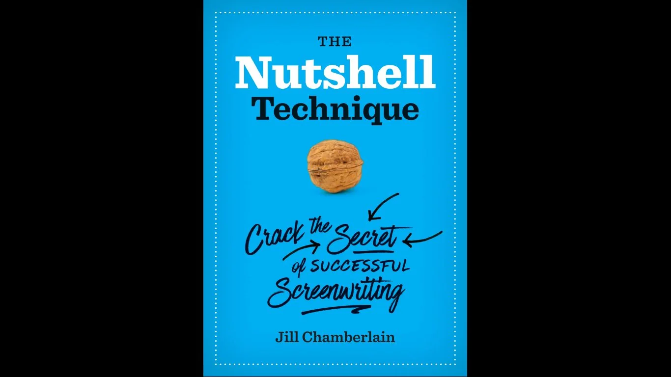 The image is a cover of Jill Chamberlain's book titled "The Nutshell Technique." The background is a vibrant blue, giving the cover a bright and engaging appearance. At the center is an image of a walnut, symbolizing the concept of "cracking" the secret of successful screenwriting. Above the walnut, the title "The Nutshell Technique" is displayed in bold, white and black lettering. Below the walnut, the phrase "Crack the Secret of Successful Screenwriting" is handwritten in a dynamic style, emphasizing the book’s aim to reveal key insights into crafting screenplays. Jill Chamberlain's name is printed at the bottom, signifying her authorship. The cover's design is simple yet effective, using minimal elements to convey its message clearly. The dotted border adds a subtle decorative touch, framing the content neatly.