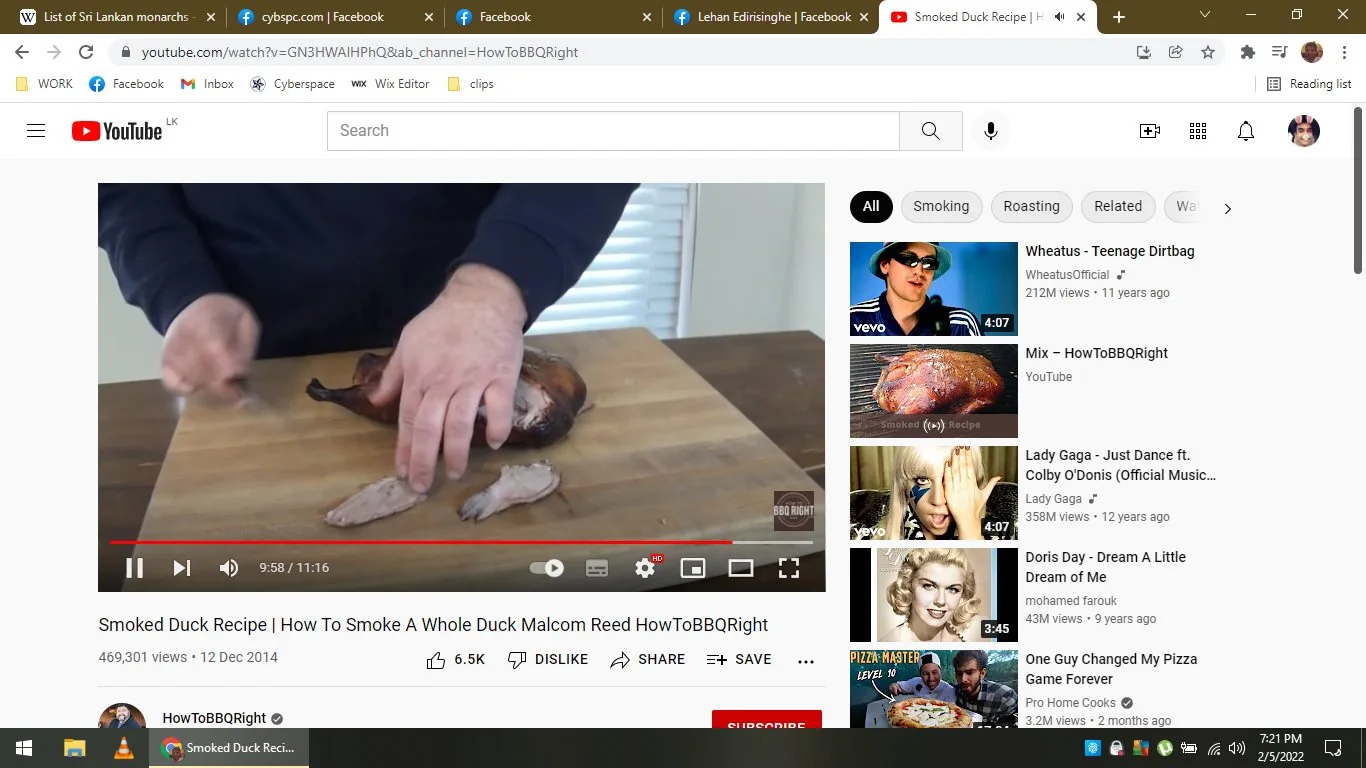 The image is a screenshot from a YouTube video titled "Smoked Duck Recipe | How To Smoke A Whole Duck Malcom Reed HowToBBQRight" on the channel HowToBBQRight. The video demonstrates the process of smoking a whole duck, with a focus on food preparation. In the foreground, a pair of hands, likely belonging to Malcom Reed, are carving a smoked duck on a wooden cutting board. The duck appears well-cooked, with a rich, dark brown color indicating the smoking process.
The setting is likely a kitchen, given the presence of cooking equipment and the indoor lighting. The atmosphere is instructional, aiming to teach viewers how to prepare the dish. The YouTube interface is visible, showing that the video has 469,301 views and was uploaded on December 12, 2014. The video has received 6.5K likes. On the right, there are recommended videos, including music videos and other cooking-related content. The scene is framed to focus on the hands and the duck, with minimal background distractions, emphasizing the cooking process.