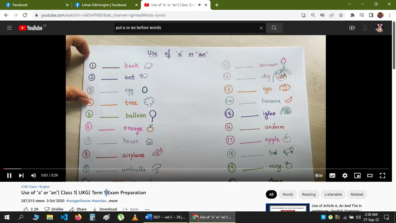 The image is a video frame from YouTube, featuring educational content titled "Use of 'a' or 'an'| Class 1 | UKG| Term 1|Exam Preparation" from the channel IgnitedMinds-Junior. The setting is a tutorial aimed at teaching young children the correct use of the articles "a" and "an" in English. The visual features a handmade chart with numbered words and accompanying illustrations, each representing a noun (e.g., book, ant, egg).
The chart is colorful, with each line written in different colors, and includes simple drawings next to the words for visual aid. There are hints on how to use "a" or "an" depending on whether the noun starts with a vowel sound or a consonant sound. A hand is visible, holding the chart, which adds a personal and interactive element to the educational content. The top of the chart reads "Use of 'a' or 'an'" in a playful handwritten font.
On-screen text includes the video title and the words from the chart. The video aims to prepare students for exams by explaining basic English grammar rules. The tags for this content are related to English grammar and language learning for young children.