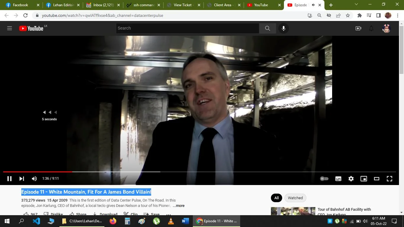 The image is a video frame from a YouTube video titled "Episode 11 - White Mountain, Fit For A James Bond Villain!" This video is part of the "datacenterpulse" channel. The scene takes place indoors, likely within a facility or similar industrial space. In the foreground is a man in business attire, wearing a dark suit and a tie, which suggests a formal or professional setting. He appears to be speaking, which, combined with the title, indicates this is likely an interview or a tour. The background is composed of industrial elements, such as metal structures and pipes, which aligns with the topic of data centers.
The lighting is artificial and somewhat dim, contributing to an industrial atmosphere. The video frame is part of a series exploring unique or high-tech data center environments, and the title suggests a dramatic or cinematic aspect. Jon Karlung, the CEO of Bahnhof, is mentioned in the text as providing a tour, which matches the visual of a speaker in a professional setting. The video has accrued a substantial number of views, and it appears to be aimed at audiences interested in technology and data infrastructure.