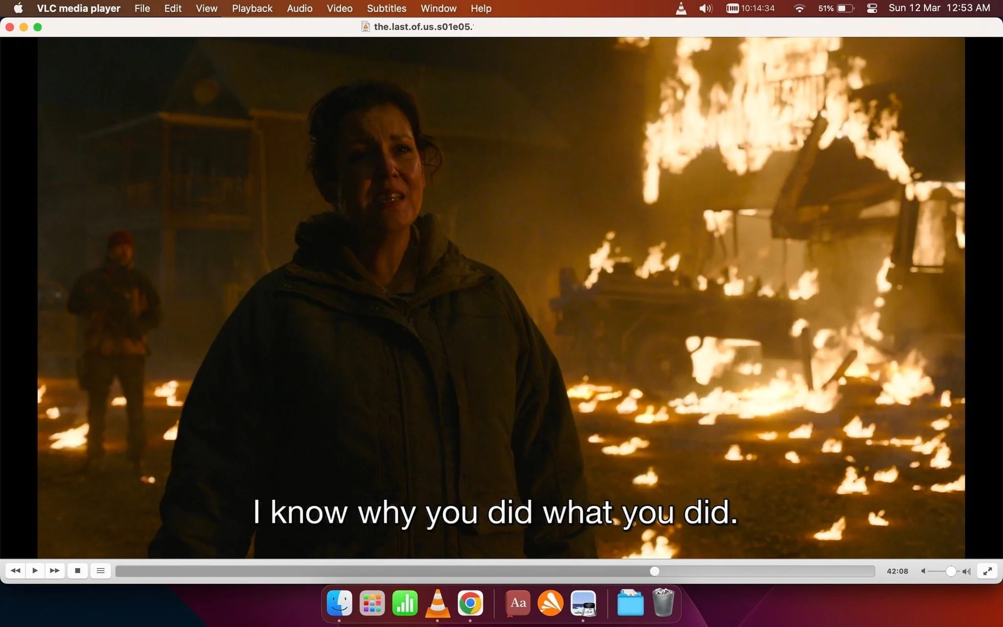 The screenshot is from a scene in the show "The Last of Us," displayed on VLC media player. It features a dramatic night setting with a woman in the foreground, wearing a dark jacket, expressing a serious emotion. Her expression suggests a moment of tension or revelation, emphasized by the subtitle, “I know why you did what you did.” The background is chaotic, with structures and a vehicle engulfed in flames, creating a fiery and intense atmosphere. The lighting casts a warm, flickering glow across the scene, highlighting the urgency and destruction. The presence of another person in the background, partially visible, adds to the tension. The scene conveys a sense of conflict and confrontation, typical of the show's dramatic narrative.
- Site / app: "VLC media player"
- Title: "the.last.of.us.s01e05.1080p.web.h264-cakes[eztv.re].mkv"
- Captions / subtitles: "I know why you did what you did."