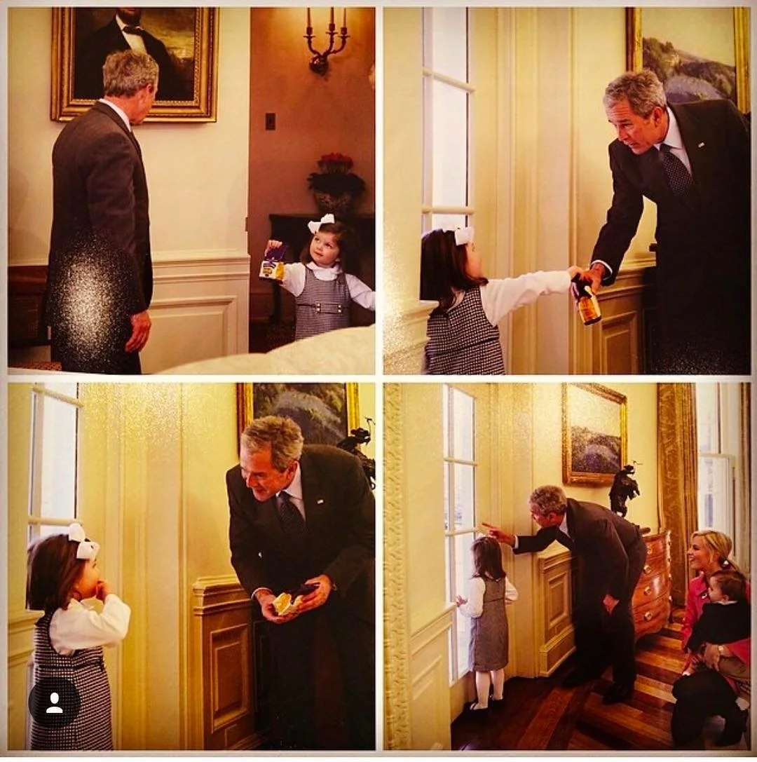 In this series of four images, George W. Bush is depicted interacting with a young girl in a formal setting, likely an office or official room. The setting is elegant, with ornate walls and a large window, suggesting it might be a government building or a similarly prestigious location. The images convey a warm and engaging interaction between the former president and the child.
In the top left image, George W. Bush is seen looking at the young girl, who is presenting him with a small item, possibly a snack or gift. The girl is dressed in a checked dress with a white blouse and a large bow in her hair, looking up at him with an expression of excitement or curiosity.
The top right image captures the moment when George W. Bush is reaching out to receive or exchange an item with the girl. Both appear engaged and friendly, highlighting the informal and approachable aspect of the interaction.
The bottom left image shows George W. Bush bending down to the girl's level, smiling warmly as he interacts with her, showcasing an affable and approachable demeanor.
In the bottom right image, George W. Bush, alongside a woman sitting on the floor with another child, is seen pointing out something through the window to the young girl. This image encapsulates a family-friendly and relaxed atmosphere, further emphasized by his attentive posture and the woman's smile.
The lighting in all images is warm and soft, enhancing the cordial and intimate feel of the interaction.