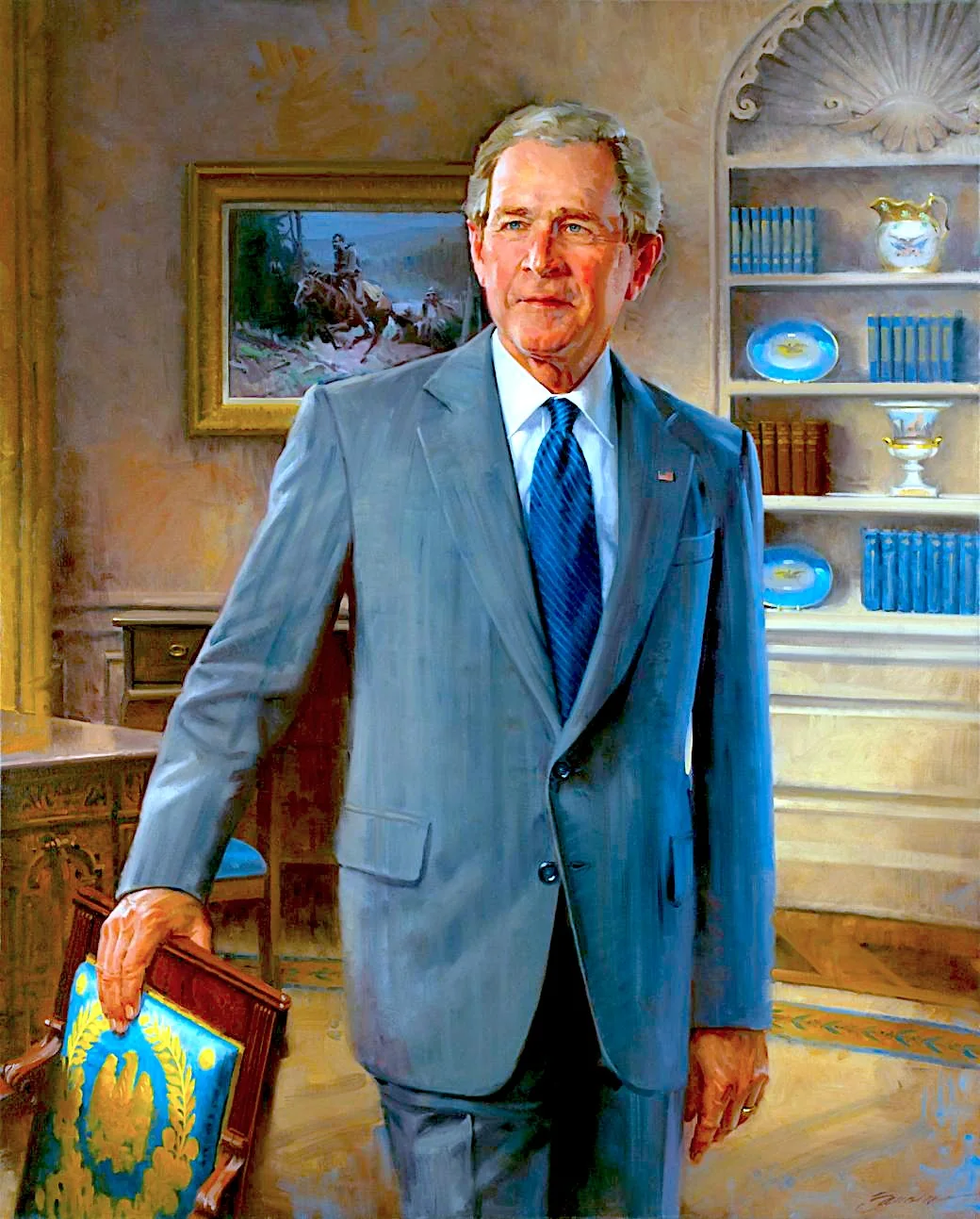 ```
This is an illustration of George W. Bush depicted in a formal setting, likely an office. The painting shows him wearing a tailored blue suit with a matching blue tie, standing with a confident posture. His expression is composed and thoughtful, capturing a sense of dignity. He is holding the back of an ornately designed chair with blue and gold upholstery, adding elegance to the scene.
In the background, there is a bookshelf filled with books and decorative plates, enhancing the sophisticated atmosphere. A framed picture depicting a historical or equestrian scene hangs on the wall, contributing to the traditional and stately environment. The lighting is warm, highlighting the textures in the painting and creating a welcoming ambiance. The overall style is realistic, emphasizing the subject’s features and the richness of the surroundings.