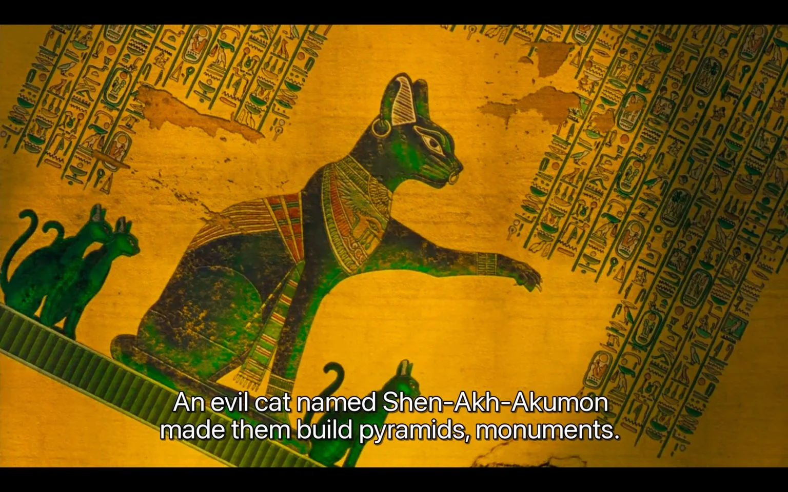 The image is an illustration with an ancient Egyptian style, depicting a large, imposing cat adorned with intricate jewelry and regal attire, suggestive of a deity or figure of power. This character is identified in the subtitles as "Shen-Akh-Akumon," described as an "evil cat" that commanded others to build pyramids and monuments. The artwork features rich greens and golds, typical of Egyptian art, with hieroglyphics framing the scene, adding authenticity and depth. The background is a textured, ancient-looking parchment, enhancing the historical feel. Two smaller cats flank the larger figure, possibly indicating followers or subjects. The overall mood is mysterious, with a focus on mythology and ancient power. The lighting is even, highlighting the detailed patterns on the cat's attire and the hieroglyphics.
- Captions / subtitles: "An evil cat named Shen-Akh-Akumon made them build pyramids, monuments."