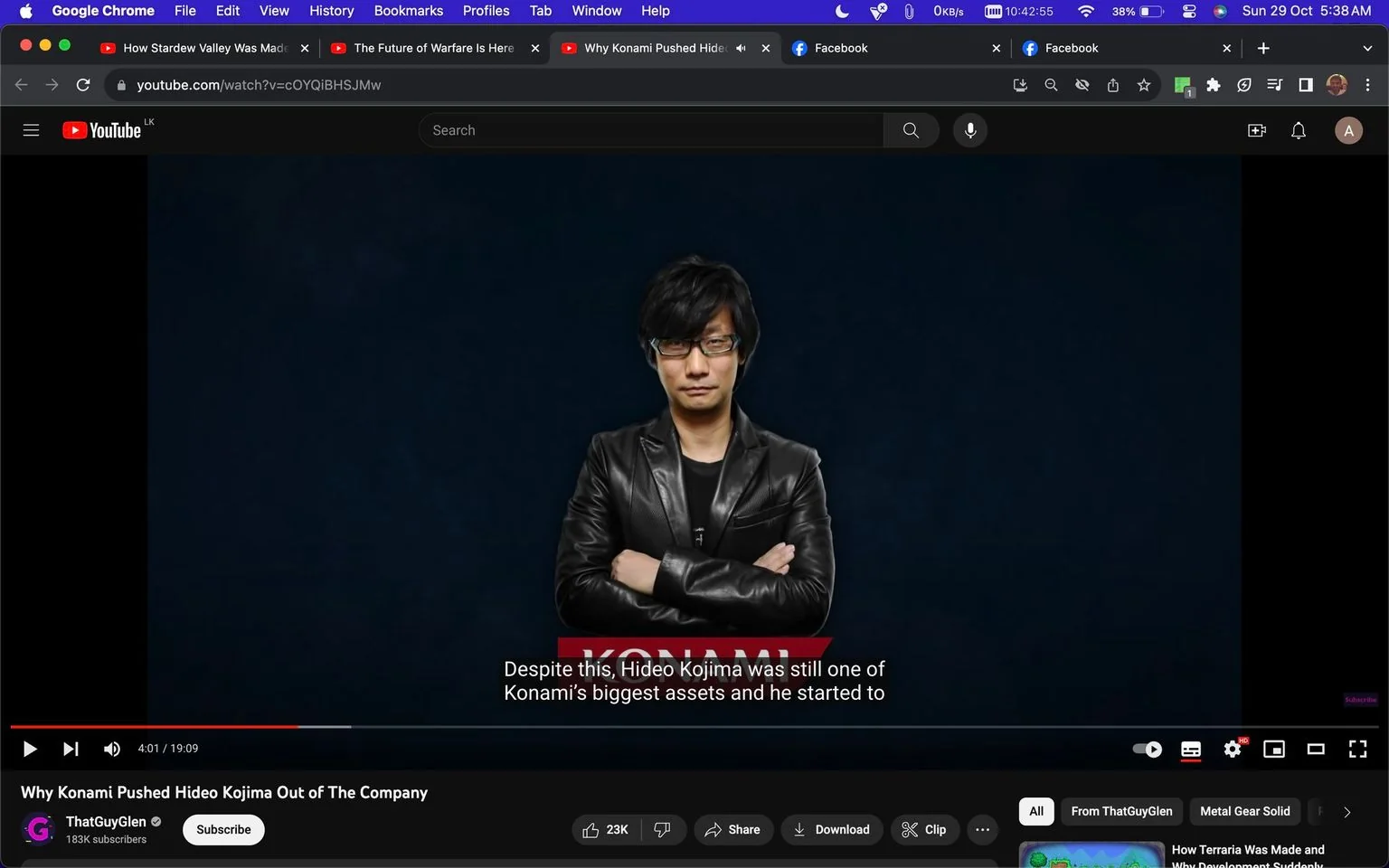Hideo Kojima is featured in a video frame from a YouTube video titled "Why Konami Pushed Hideo Kojima Out of The Company," hosted on the channel ThatGuyGlen. The frame captures Kojima, wearing a black leather jacket, standing with his arms crossed. He appears composed and confident, set against a dark blue background that emphasizes his figure. The lighting is professional, casting soft highlights on his jacket and giving depth to the scene.
The YouTube interface is visible, showing various tabs at the top, including "How Stardew Valley Was Made" and "The Future of Warfare Is Here." The video is currently at 4:01 out of 19:09, with subtitles on screen reading, "Despite this, Hideo Kojima was still one of Konami's biggest assets and he started to." Below, the channel, ThatGuyGlen, is displayed with a subscriber count of 183K.
A red strip with the text "KONAMI" adds context to the topic being discussed. This setup is typical for a documentary-style video, providing insight into industry topics. The presence of options such as like, share, and download underlines the interactive nature of the platform.