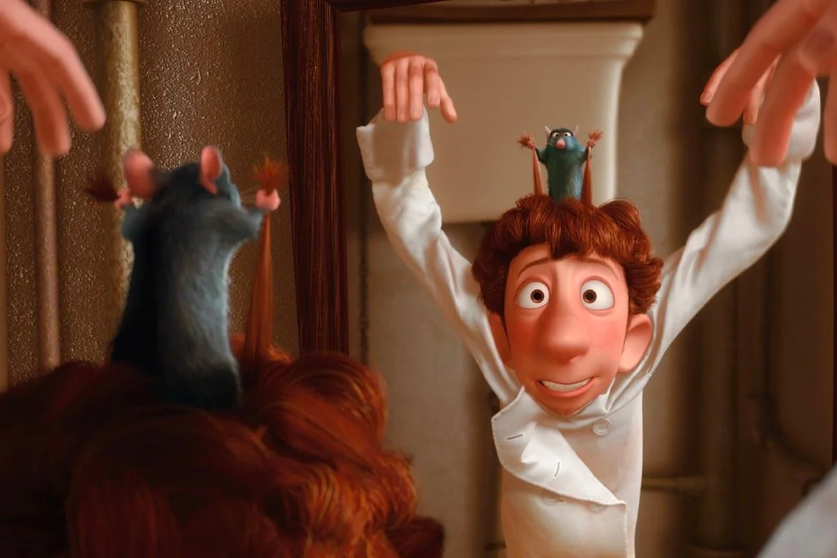 In this animated scene from the film "Ratatouille," a young chef, wearing a white chef's coat, is shown with an amused and slightly nervous expression. The setting is likely a kitchen or a similar indoor environment, evident from the pipes and practical decor in the background. On top of the chef's head, a small rat stands, pulling on his hair to guide him, which is a comedic element central to the movie's plot. The rat, with gray fur and pink ears, is animated with a lively demeanor, mimicking the movements of a conductor. The chef's reddish-brown hair and the rat's contrasting colors create a visually striking image. The lighting is warm, suggesting a cozy kitchen atmosphere. This scene captures the humorous and whimsical tone of the film, emphasizing themes of teamwork and unexpected partnerships in the culinary world.