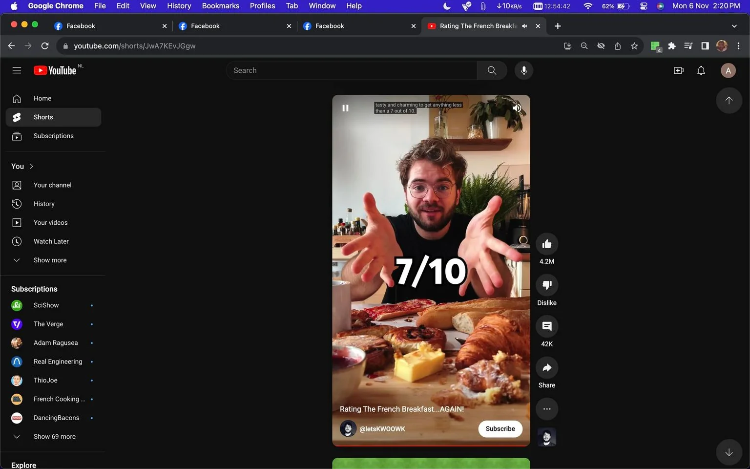 The image is a screenshot from a YouTube video titled "Rating The French Breakfast...AGAIN!" by the channel @letskWOOWK. The setting is a cozy kitchen or dining area with a wooden table in the foreground laden with various breakfast items typical of a French breakfast. Visible are croissants, bread, cheese, pastries, and a jar of jam, indicating a focus on a culinary review.
A man, possibly the host from @letskWOOWK, is seated behind the table, gesturing expressively with his hands as if explaining or reviewing something. He has a friendly demeanor, with curly hair and wearing glasses, creating an engaging and approachable atmosphere. The text "7/10" is prominently displayed over the scene, likely representing the host's rating of the breakfast. In the background, there are plants and kitchen appliances, enhancing the homely and inviting setting.
The lighting is bright and natural, emphasizing the freshness and appeal of the food items. The video includes captions, one of which reads, "tasty and charming to get anything less than a 7 out of 10," suggesting a positive yet critical review. The user interface of the YouTube platform is visible, with options to like, dislike, and share the video, as well as a subscribe button for the channel.