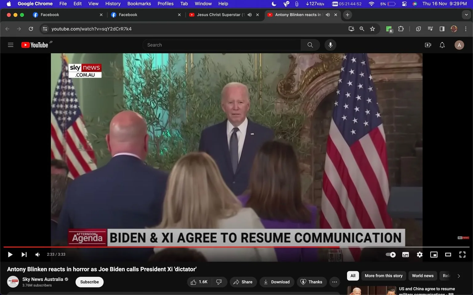 The image is a video frame from a YouTube video titled "Antony Blinken reacts in horror as Joe Biden calls President Xi 'dictator'" on the Sky News Australia channel. The scene is set indoors during what appears to be a press conference or a diplomatic meeting. In the center, Joe Biden, dressed in a dark suit and tie, stands in front of a group of people who are mostly turned away from the camera. The backdrop includes an American flag and some ornamental greenery, lending a formal and official atmosphere to the setting.
The lighting is bright, highlighting Biden as the focal point of the frame. The audience, whose backs are mostly visible, include individuals with varied hair colors and attire, giving a sense of a diverse group gathered for this event. The text at the bottom of the screen reads "BIDEN & XI AGREE TO RESUME COMMUNICATION," indicating the diplomatic context of the discussion. The Sky News Australia logo is visible in the top left corner, and the video is paused at 2:33 out of a 3:33 runtime. This frame captures a moment during a significant political discourse involving high-profile international relations.