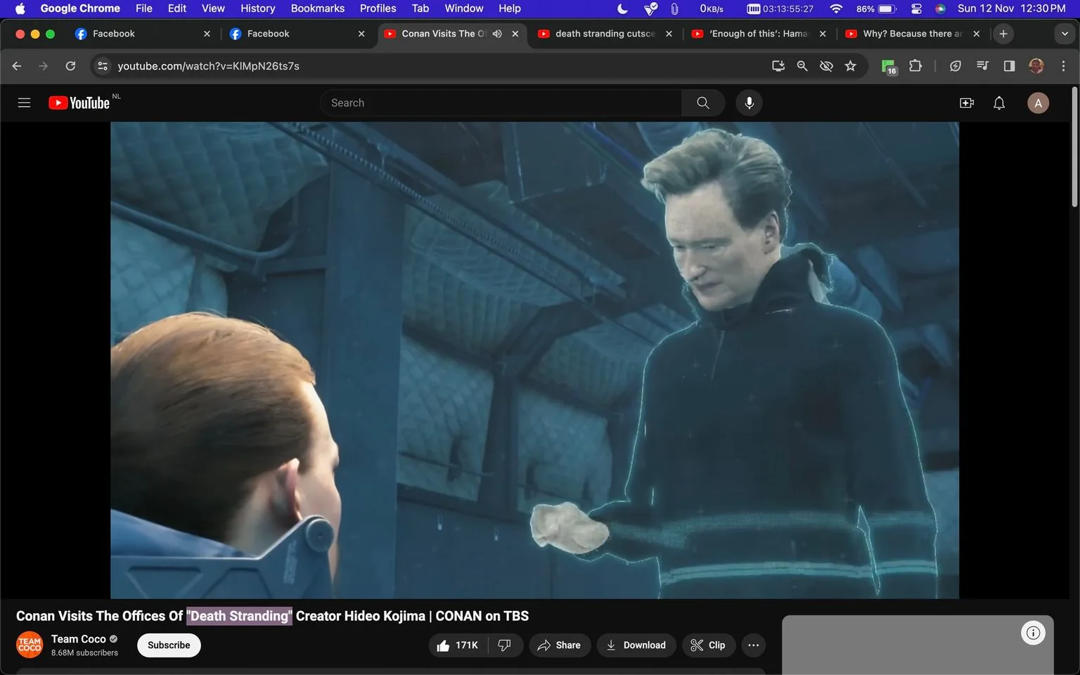 The image is a video frame from a YouTube video titled "Conan Visits The Offices Of 'Death Stranding' Creator Hideo Kojima | CONAN on TBS," which is published on the "Team Coco" channel. The scene features an animated version of Conan interacting with a character within the video game "Death Stranding." Conan appears as a holographic figure, wearing a dark hoodie and standing in what seems to be an industrial or futuristic setting, indicated by the metallic walls and ambient blue lighting. He is mid-conversation with a character whose back is turned to the viewer, likely a scene from the game itself. The animation style is detailed and realistic, capturing Conan's distinct hairstyle and expressions. The overall mood is lighthearted, as the presence of a celebrity in a game often suggests humor or an Easter egg. The frame neatly captures the blending of celebrity culture with video game storytelling, showcasing Conan's characteristic charm in a digital form.
- Title: "Conan Visits The Offices Of 'Death Stranding' Creator Hideo Kojima | CONAN on TBS"
- Channel / profile: "Team Coco"
- Site / app: "YouTube"