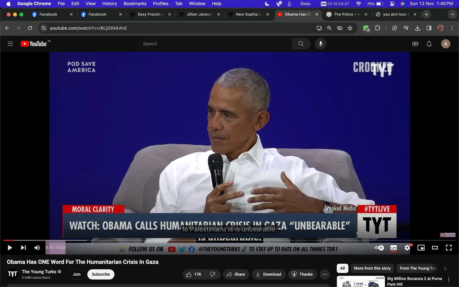 The image is a video frame from a YouTube video featuring Barry Obama in an interview or discussion setting. The scene shows him seated in a comfortable chair, wearing a white shirt, and holding a microphone. He appears engaged in conversation, using expressive hand gestures. The background is a solid blue with "POD SAVE AMERICA" and "CROOKED MEDIA" text visible, indicating the setting or affiliated media. The text overlay at the bottom of the video reads, "WATCH: OBAMA CALLS HUMANITARIAN CRISIS IN GAZA 'UNBEARABLE'," and the channel "TYT" (The Young Turks) is noted with "#TYTLIVE" on the screen. The video title suggests that Obama is addressing issues related to the humanitarian crisis in Gaza, describing it as "unbearable." The mood is serious and reflective, with Obama focused on elaborating on his viewpoint. The interface shows that the viewer is on YouTube, with options for liking, sharing, and subscribing to the channel visible. The presence of multiple open tabs on the browser suggests multitasking by the viewer, who is also engaged with various social media platforms.
- Title: "Obama Has ONE Word For The Humanitarian Crisis In Gaza"
- Channel / profile: "The Young Turks"
- Site / app: "YouTube"
- Captions / subtitles: "to Palestinians is is unbearable."