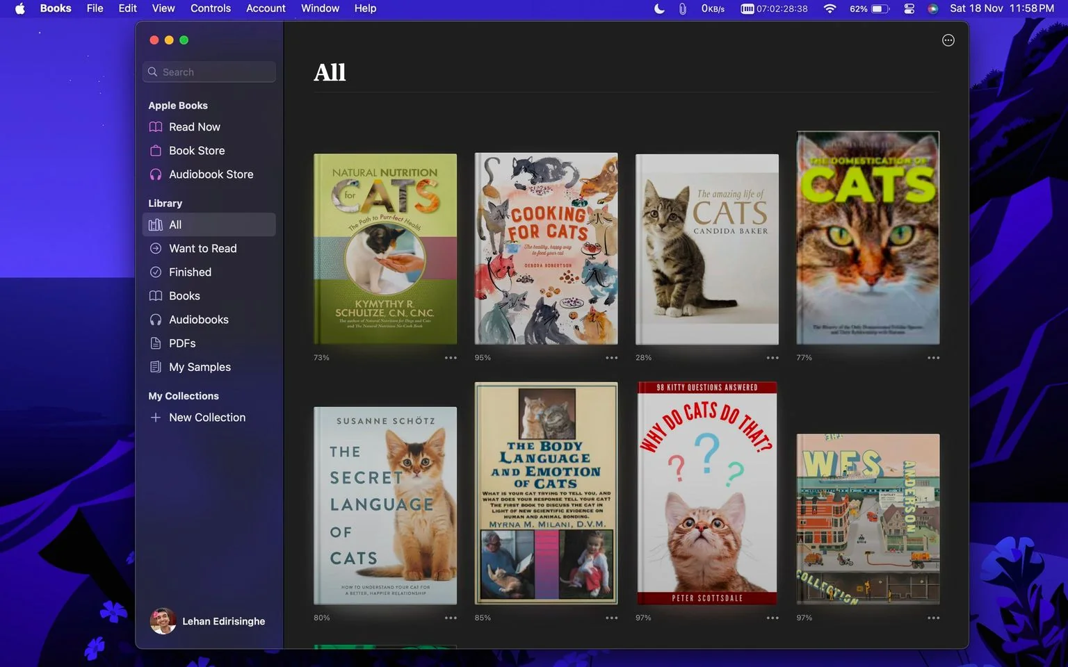 In this screenshot of the Apple Books application, the interface displays a user's digital library on a computer screen. The left panel of the screen shows various library categories like "All," "Want to Read," and "Finished," along with the user's profile picture labeled "Lehan Edirisinghe." The main section showcases a selection of books, each with a colorful cover prominently featuring cats.
The titles visible include "Natural Nutrition for Cats," which is partly downloaded at 73%, "Cooking for Cats," at 95%, and "The Amazing Life of Cats" at 28%. Each book cover is designed with images of cats, emphasizing themes of nutrition, lifestyle, and behavior specific to feline companions. The cover of "Why Do Cats Do That?" features a curious kitten with a backdrop of question marks, suggesting an exploratory approach to cat behavior. The layout is user-friendly, with a dark background contrasting the vibrant book covers. The scene is set at night, as suggested by the time stamp in the upper corner, and the interface is cleanly organized, typical of a digital library environment. The overall mood is informative and engaging for anyone interested in feline topics.
- Title: "All"
- Site / app: "Apple Books"
