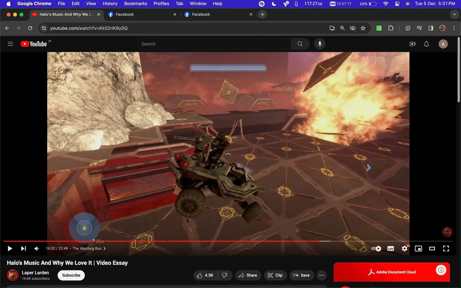 The image is a screenshot from a YouTube video titled "Halo's Music And Why We Love It | Video Essay," created by the channel Laper Larden, which has 14.6K subscribers. The video appears to be a detailed exploration of the music in the Halo video game series. The screenshot captures an intense gameplay moment featuring a Warthog vehicle from Halo, amid a fiery explosion on a futuristic, geometric platform. The scene is set against a dramatic red sky with rocky terrain visible, creating a sci-fi atmosphere. The explosion is vibrant, adding dynamic energy to the frame. The player interface shows typical gaming elements such as a health or shield bar and targeting reticle. The video timeline indicates it is 16 minutes and 2 seconds into the 22 minute and 48 second essay, specifically during "The Warthog Run" segment. The YouTube interface is visible, with options for liking, sharing, and saving the video. The screenshot also shows the browser's tabs and address bar, indicating it is viewed on Google Chrome with other tabs open for Facebook.