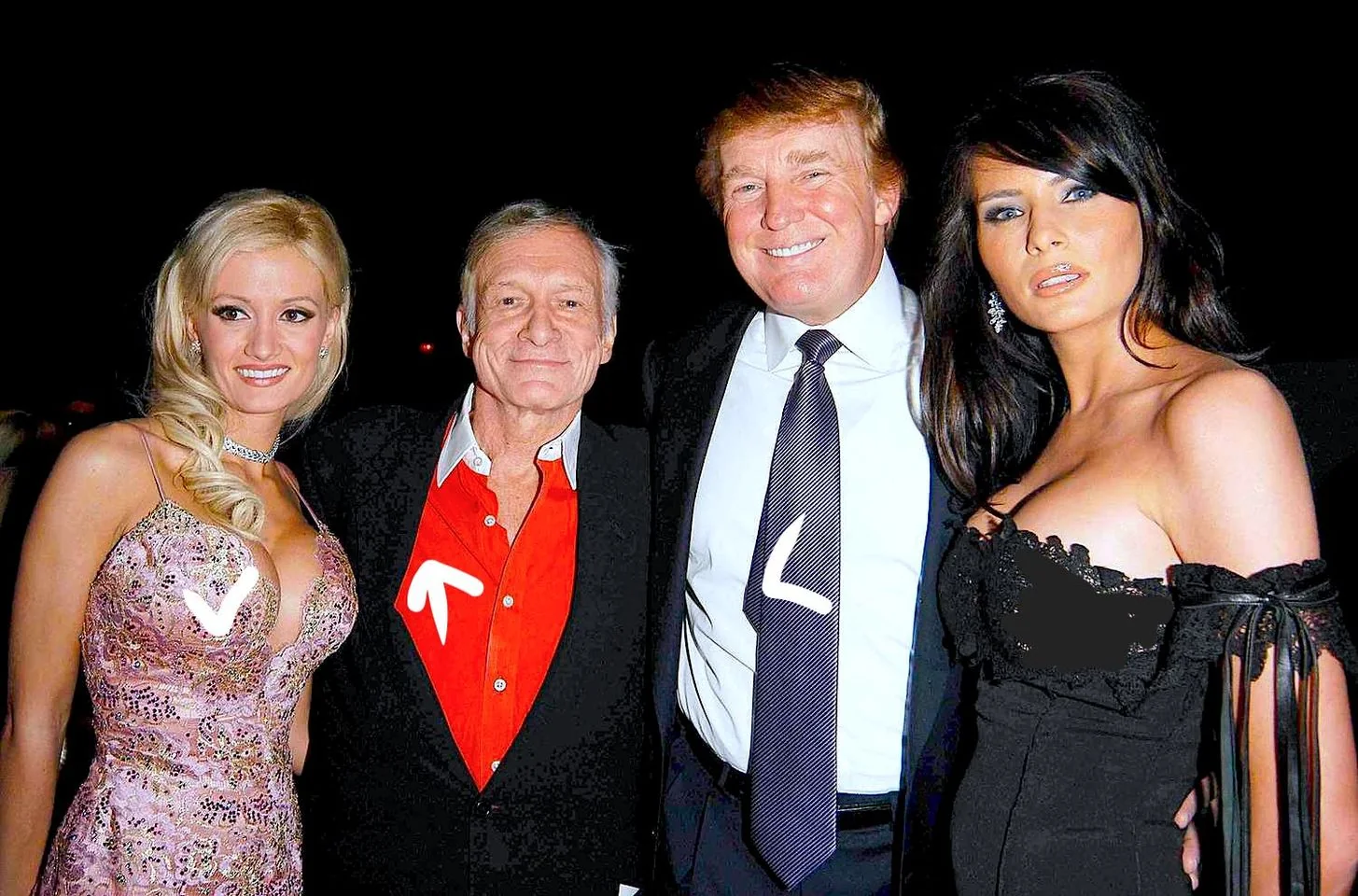In the image, there are four people posing together at what appears to be a formal event. The hint identifies one of them as President Trump, who is standing third from the left, wearing a dark suit and a striped tie. To his right is a woman in a black dress, and to his left is an older man in a red shirt and dark blazer. The woman on the far left is dressed in a pink, patterned gown. They are all smiling and standing close together, suggesting a friendly and social atmosphere. Given the setting, it looks like an evening event, possibly a gala or party, with dim lighting enhancing the formal attire of the group. The background is dark, focusing attention on the individuals in the foreground.