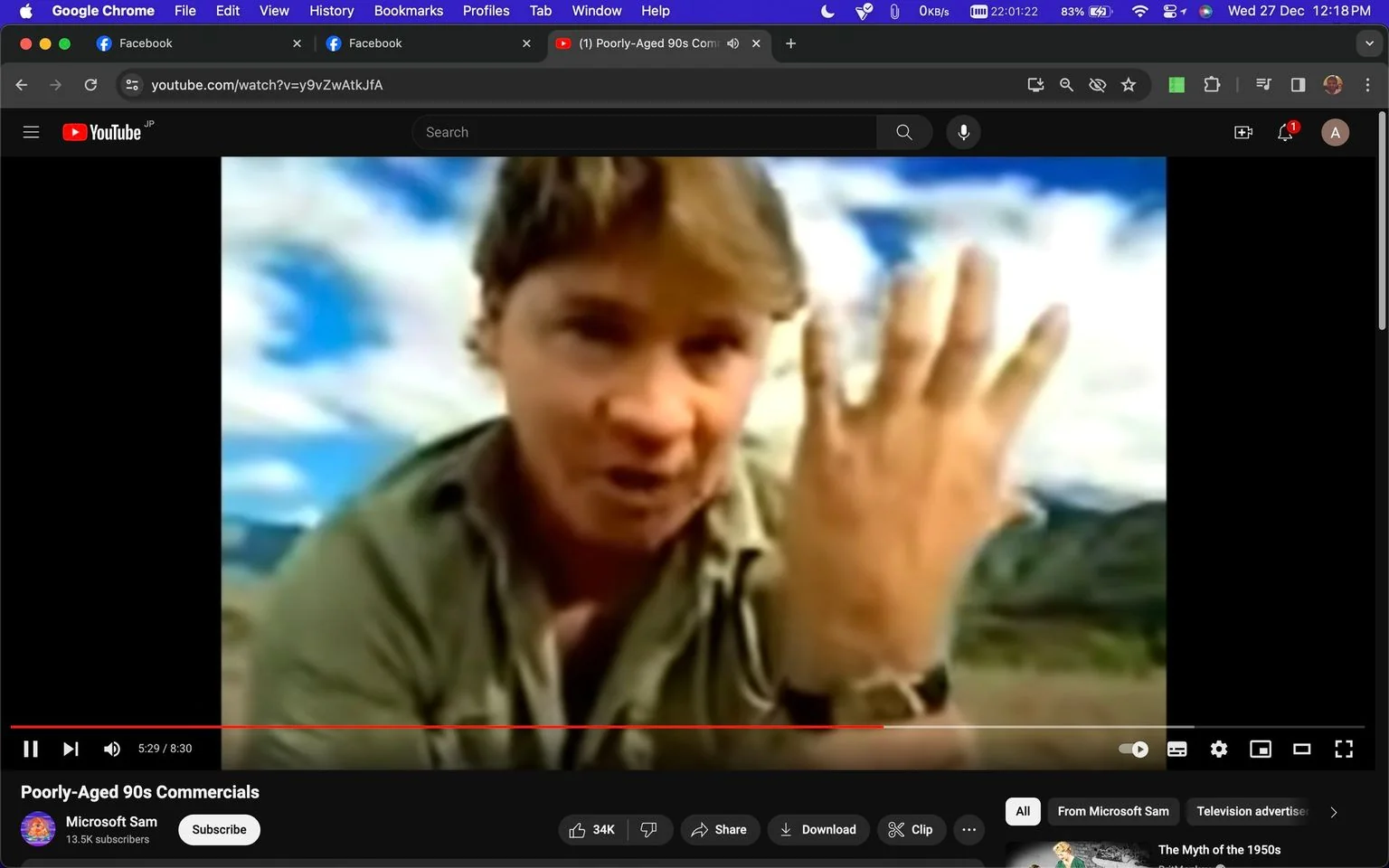 Steve Irwin is featured prominently in this video screenshot from a YouTube video titled "Poorly-Aged 90s Commercials," hosted on the channel "Microsoft Sam." The scene shows Steve Irwin outdoors, pointing towards the camera with an enthusiastic expression. His attire is a classic khaki shirt, fitting his adventurous persona. The background displays a bright, partly cloudy sky, suggesting a daytime setting. The focus on his extended hand and animated posture emphasize his dynamic storytelling style. The video seems to capture a moment from a commercial or presentation, given the context of the title. The layout of the interface shows YouTube's standard design, including options like like, share, and subscribe below the video frame.