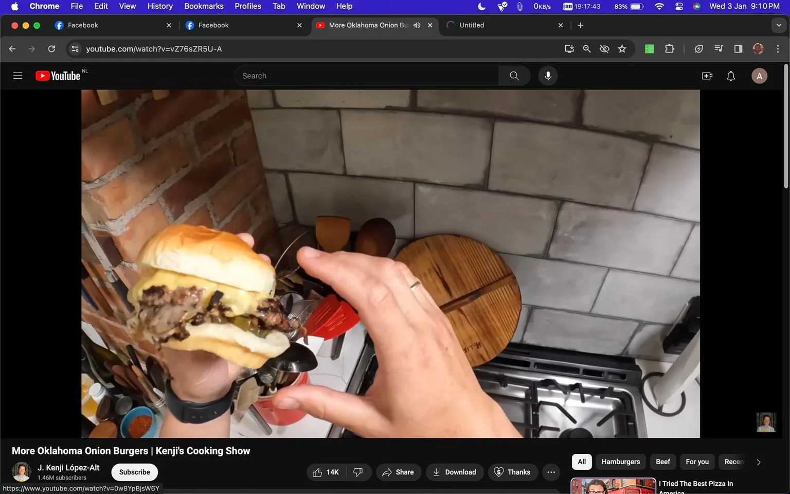 The image is a screenshot from a YouTube video titled "More Oklahoma Onion Burgers | Kenji's Cooking Show," hosted on the channel "J. Kenji López-Alt." The scene is set in a kitchen with a rustic aesthetic, featuring brick and tiled walls. In the foreground, a hand is holding a burger prominently, which appears to be an Oklahoma onion burger, characterized by a heaping of grilled onions and melted cheese in a soft bun. The close-up shot focuses on the texture and layers of the burger, emphasizing its appetizing appearance.
In the background, a gas stove is visible alongside a collection of kitchen utensils, suggesting an active cooking area. The lighting is warm, enhancing the inviting and casual mood of the scene. A round wooden cutting board is also visible, adding to the rustic kitchen ambiance. The video seems to be part of a cooking series where culinary techniques are showcased in a hands-on manner.
- Title: "More Oklahoma Onion Burgers | Kenji's Cooking Show"
- Channel / profile: "J. Kenji López-Alt"
- Site / app: "YouTube"