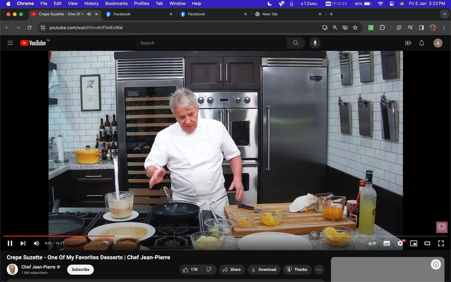 Chef Jean-Pierre is conducting a cooking demonstration in a well-equipped kitchen. The setting is a modern kitchen with white subway tile walls, stainless steel appliances, and a countertop filled with ingredients for making crepes. Chef Jean-Pierre is dressed in a classic white chef's uniform, adding a professional touch to the scene. In front of him, there is a frying pan on the stove, likely for making the crepes. Various ingredients including orange slices, a bottle of liquor, and mixing utensils are visible on the wooden cutting board beside him.
The background features a wine cooler and a collection of bottles arranged neatly, suggesting a sophisticated and organized kitchen environment. Chef Jean-Pierre appears focused and engaged as he explains the process of making Crepe Suzette, a classic French dessert. The lighting is bright, highlighting the clean and inviting ambiance of the kitchen. The YouTube interface shows the video title and the channel name, "Chef Jean-Pierre," along with the subscriber count, emphasizing the chef's popularity and expertise in culinary arts.