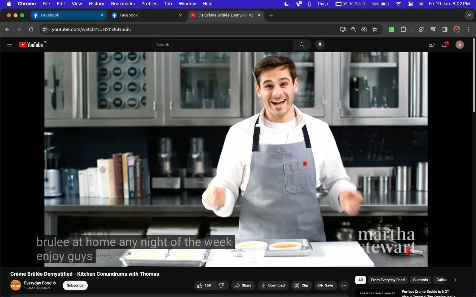 The image is a screenshot from a YouTube video titled "Crème Brûlée Demystified - Kitchen Conundrums with Thomas." The video is hosted on the Everyday Food channel, published by Martha Stewart. The setting is a modern kitchen with stainless steel cabinets and various kitchen appliances in the background. Thomas, the host, is enthusiastically presenting, wearing a light-colored shirt with a gray apron. He appears to be in the middle of a cooking demonstration, with crème brûlée dishes on the counter in front of him. The lighting is bright, creating a clean and inviting atmosphere. Books and containers are visible on the shelves, adding to the culinary setting. The mood is educational and engaging, as Thomas seems eager to share tips with the audience. Captions in the image show part of his dialogue, with him encouraging viewers to enjoy making crème brûlée at home any night of the week.
- Title: "Crème Brûlée Demystified - Kitchen Conundrums with Thomas"
- Channel / profile: "Everyday Food"
- Site / app: "YouTube"
- Captions / subtitles: "brulee at home any night of the week enjoy guys"