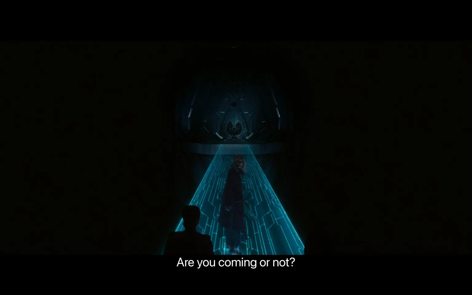 In this image, the scene is set in a dimly lit, futuristic environment. A blue holographic path is illuminated in the center, leading towards a large, intricate metallic structure. A person stands on this path, facing slightly backward, suggesting they are leading or inviting others to follow. The background is predominantly dark, enhancing the glowing effect of the holographic path. The attire of the person appears futuristic and blends with the setting, indicating a possible sci-fi context. The mood is tense, as indicated by the subtitle, "Are you coming or not?" which implies urgency or impatience. The setting suggests a high-tech environment, possibly within a spacecraft or advanced facility. The composition focuses on the interplay between light and shadow, emphasizing the technological theme. This scene is likely from a video game, given the association with "Halo CE."
- Captions / subtitles: "Are you coming or not?"