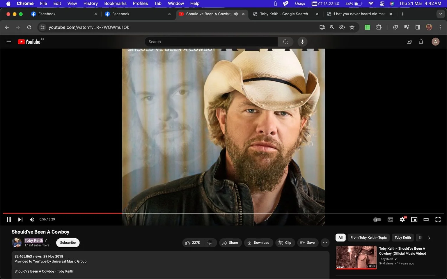 The image is a screenshot from YouTube featuring a video titled "Should've Been A Cowboy" by Toby Keith. It shows a close-up of a man with a beard wearing a cowboy hat and a black leather jacket, indicating a country music theme. The background includes a faded image of the same man, adding a layered visual effect. The text on the screen confirms the artist as Toby Keith, with the video being provided by Universal Music Group. The video's view count and upload date are also visible, showcasing its popularity. The interface displays typical YouTube elements, such as the video title, view count, and options for liking or sharing. The overall mood is rugged and thematic, focusing on country and cowboy motifs.