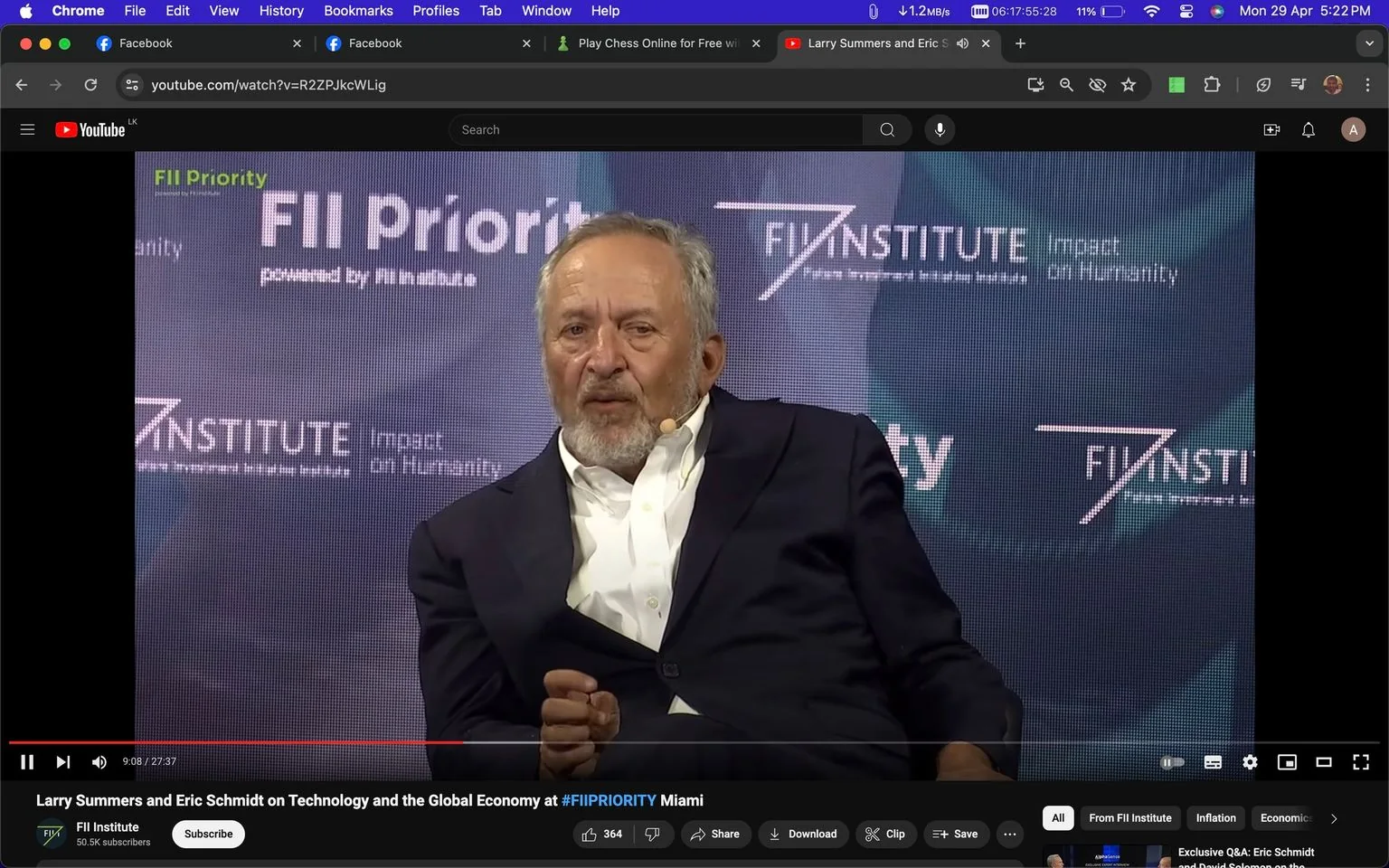 Larry Summers is seen speaking at an event titled "Larry Summers and Eric Schmidt on Technology and the Global Economy at #FIIPRIORITY Miami." The screenshot captures him mid-discussion, seated in front of a backdrop that prominently features the FII Institute's branding, including phrases like "FII Priority" and "Impact on Humanity." He is dressed in a formal dark suit with a white shirt, and a microphone is clipped to his lapel, indicating he is part of a panel or interview. The setting appears professional and focused, with dim lighting centered on Summers, emphasizing his role as the speaker. The composed demeanor and engaged expression suggest a serious yet approachable discussion. The video is hosted on YouTube, specifically on the FII Institute's channel, highlighting the intersection of technology and the global economy as key themes of the conversation.