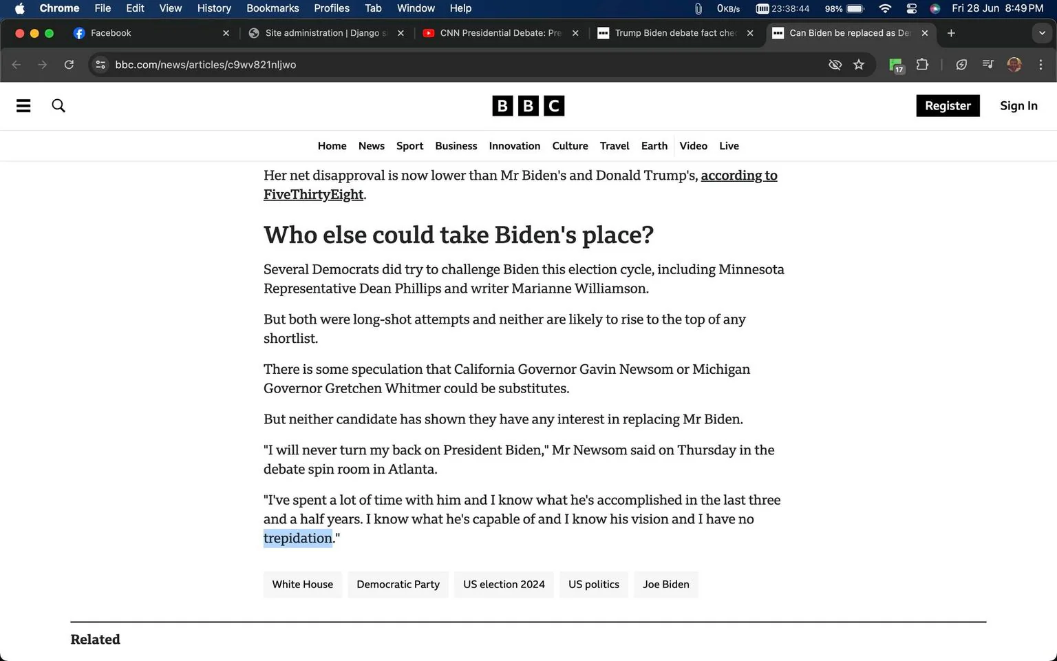 The image is a screenshot of an article from the BBC News website. The headline reads, "Who else could take Biden's place?" The article discusses potential Democratic contenders who could challenge President Biden in the upcoming election. It mentions Minnesota Representative Dean Phillips and writer Marianne Williamson, noting that both attempts are long shots. The article also speculates on whether California Governor Gavin Newsom or Michigan Governor Gretchen Whitmer might be possible candidates. However, it states that neither has shown interest in replacing President Biden. A quote from Mr. Newsom is included, where he expresses his continued support for President Biden and confidence in his leadership.
The webpage is clearly branded with BBC elements, with navigation options like "Home," "News," "Sport," and more visible at the top. The layout is typical of a news site, with text occupying the majority of the space. The interface shows browser tabs open for Facebook, Django, and CNN, suggesting a focus on news and social media. The overall tone of the article appears informative and analytical, reflecting on political dynamics within the Democratic Party.