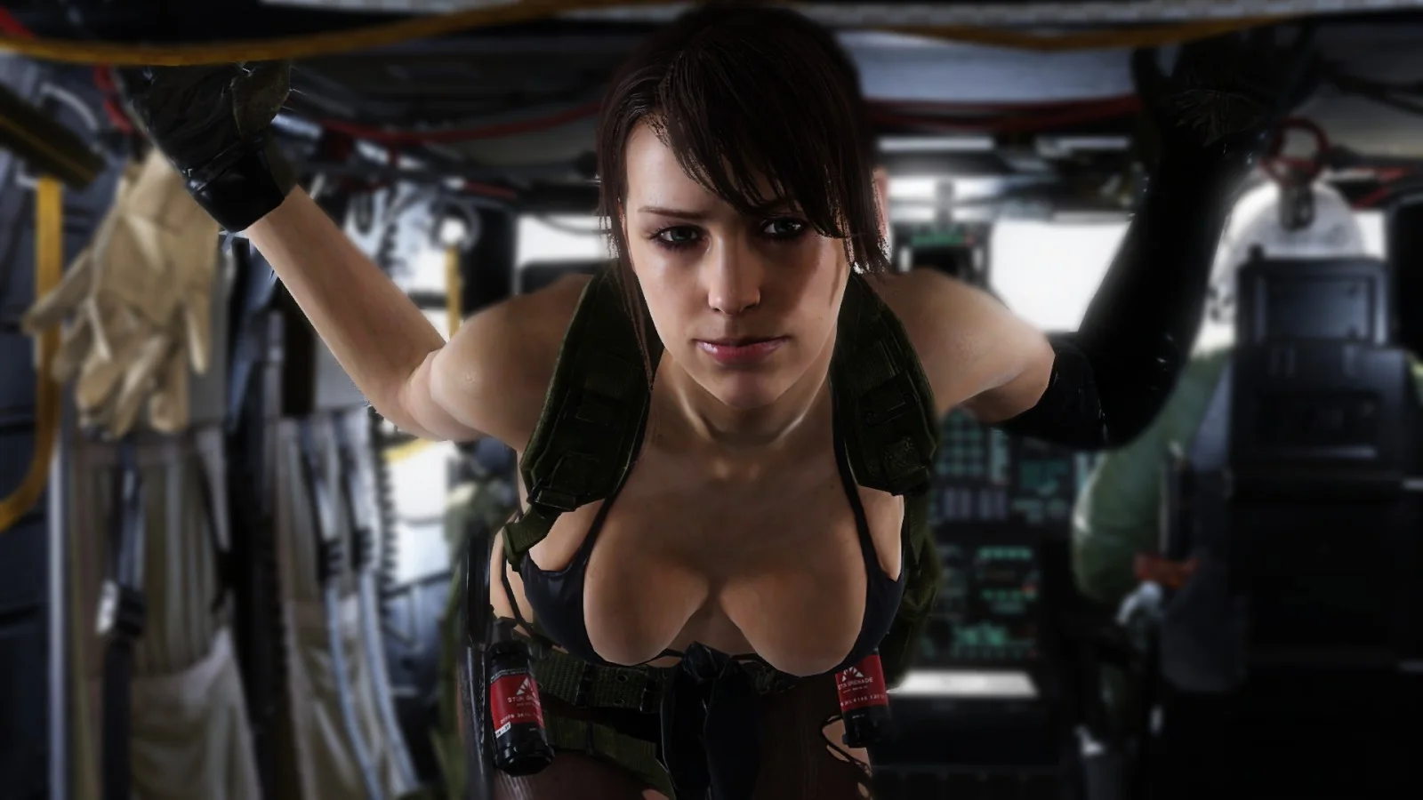 The image is an illustration from the video game "Metal Gear Solid V: The Phantom Pain." It features the character Quiet inside a helicopter, which is filled with military equipment. The setting is tight and action-packed, reflecting a military atmosphere. Quiet is leaning forward, supporting herself with her hands on the ceiling of the aircraft. She wears a tactical vest and minimal clothing, fitting her character's design within the game. Her expression is focused and intense, indicating readiness or contemplation. The lighting inside the helicopter is dim, highlighting her features against a blurred, complex background of equipment and controls. The overall color palette is muted, with greens and browns dominating, emphasizing the military theme.