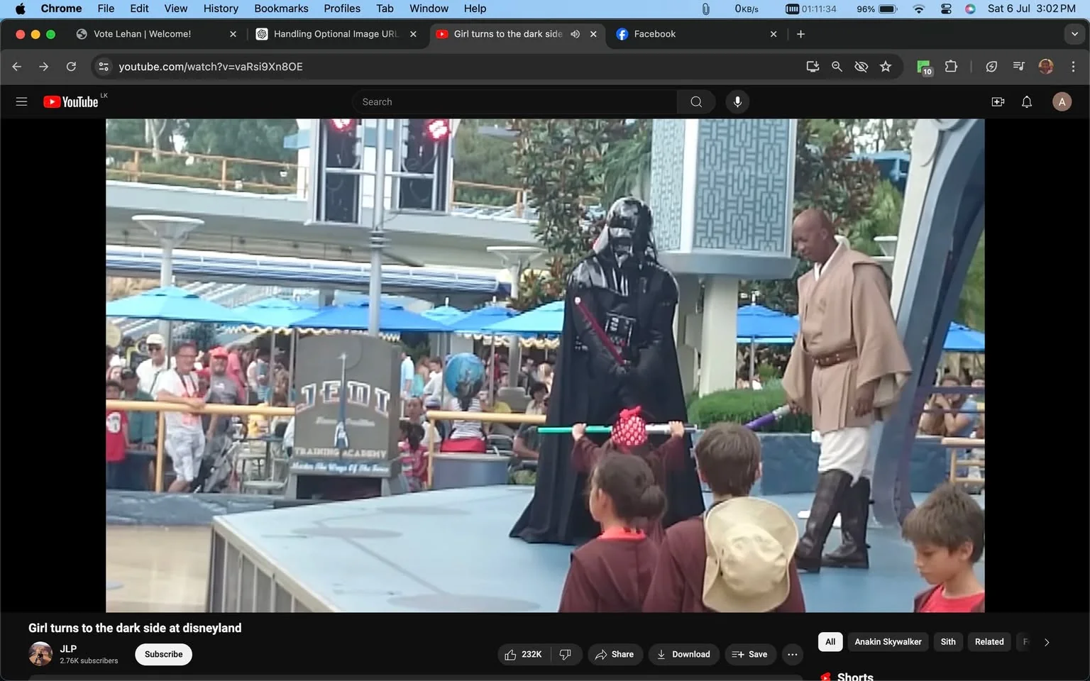 This image is a screenshot from a YouTube video titled "Girl turns to the dark side at disneyland" on the channel "JLP." It depicts a scene at what appears to be Disneyland, specifically at a Jedi Training Academy performance. In the center, a character dressed as a Sith, reminiscent of Darth Vader from "Star Wars," is interacting with children on stage. The Sith is clad in a black costume, complete with a helmet and cape, and holds a red lightsaber. To the right, another performer is dressed in a Jedi costume with a beige robe and brown boots, wielding a purple lightsaber.
In the foreground, several children in brown Jedi robes are present, one of whom is directly interacting with the Sith character. The child holds a training lightsaber with a green and blue blade. The background features an audience watching the event, with some seated under blue umbrellas. Signs in the background read "JEDI Training Academy" and "Feel the Ways of the Force," suggesting this is part of a themed attraction. The setting is outdoors, lively, with colorful elements and a playful atmosphere, typical of a theme park environment.
- Title: "Girl turns to the dark side at disneyland"
- Channel / profile: "JLP"
- Site / app: "YouTube"