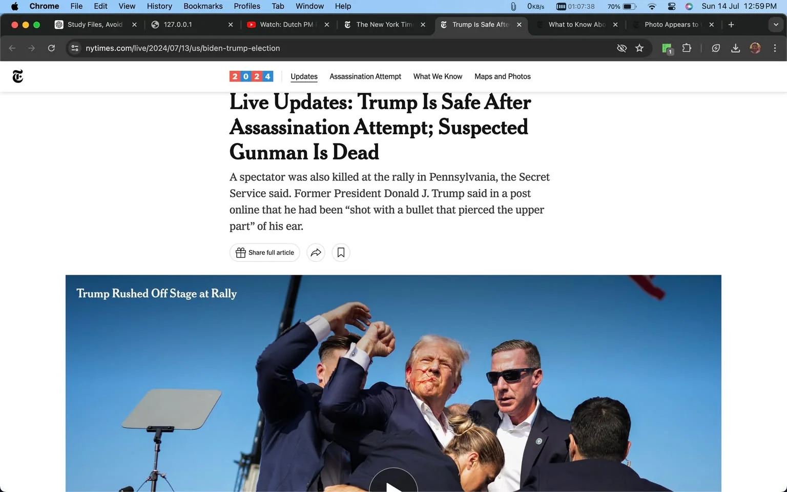 ```
1) Rich description (8–12 sentences): The image shows a dramatic scene at a rally where Donald Trump is being hurriedly escorted off stage by security personnel. Donald Trump appears in the center of the image with a concerned expression, showing a visible injury on his face. He is flanked by men in dark suits, one of whom is identified as Sean Curran, providing security. The scene is set against a clear blue sky, indicating an outdoor rally. The lighting is bright and natural, emphasizing the urgency and seriousness of the situation. Several people surround Trump, illustrating a tense and protective atmosphere. In the background, a teleprompter is visible, suggesting an organized event disrupted by the incident. The headline and accompanying article describe an assassination attempt with the suspected gunman reportedly dead. The image captures a moment of high alert and rapid response as Trump's security team acts swiftly to ensure his safety.
2) On-screen text block:
- Title: "Live Updates: Trump Is Safe After Assassination Attempt; Suspected Gunman Is Dead"
- Site / app: "The New York Times"