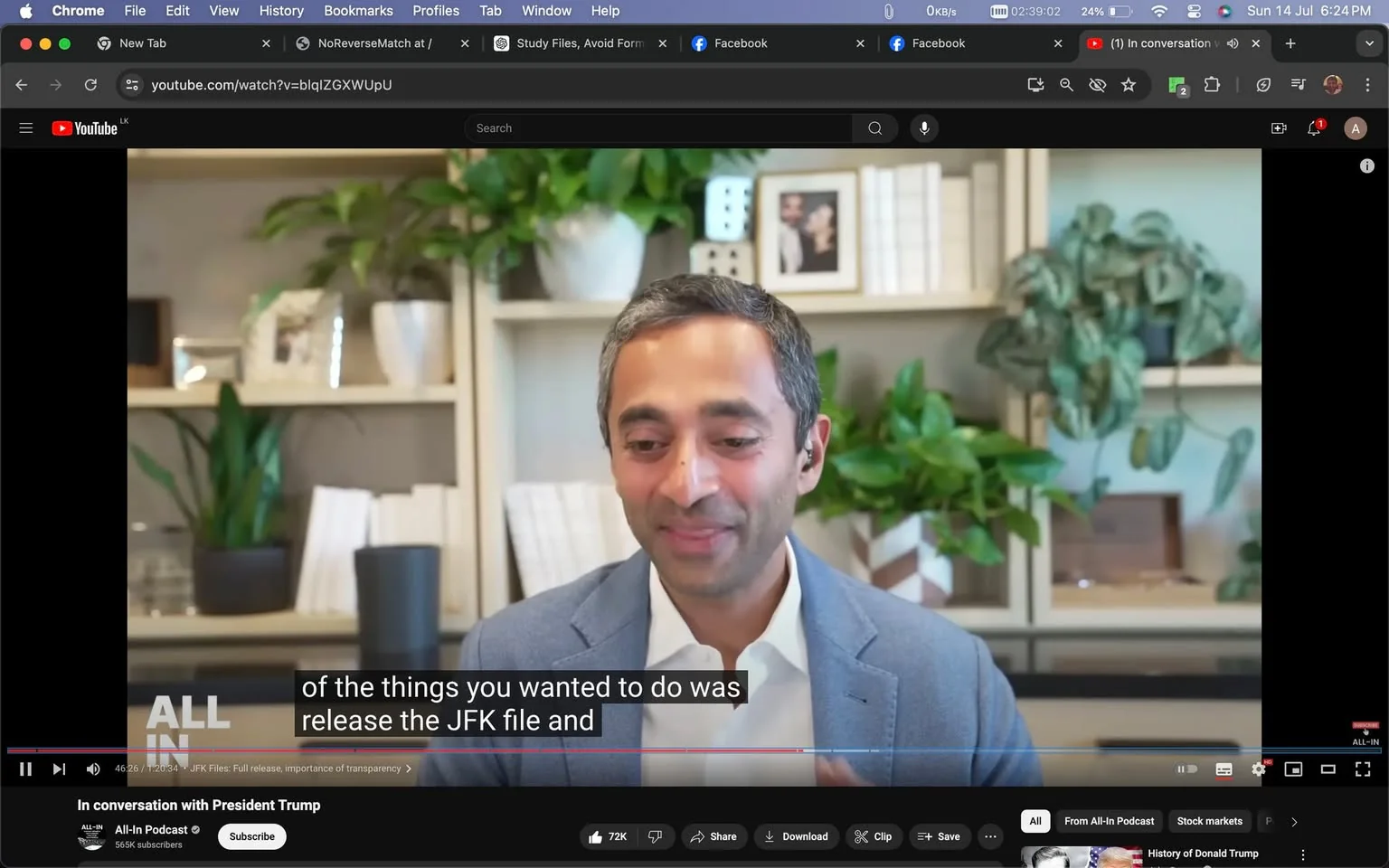 The image is a screenshot from a YouTube video titled "In conversation with President Trump" on the "All-In Podcast" channel. Chamath is featured in the scene, sitting in a well-organized office space. He is wearing a light gray blazer over a white shirt and has a slight smile, suggesting a conversational or light-hearted moment. Behind him, there are bookshelves filled with books, decorative items, and plants, creating a professional and cozy atmosphere.
The lighting is bright and natural, highlighting Chamath's facial expressions and the details of the room. The focus is on Chamath as he appears to be engaged in a discussion, possibly during an interview or podcast episode. The caption at the bottom of the screen reads, "of the things you wanted to do was release the JFK file and," indicating a discussion about the JFK files. The overall setting suggests an informal yet professional dialogue taking place in a modern office environment.