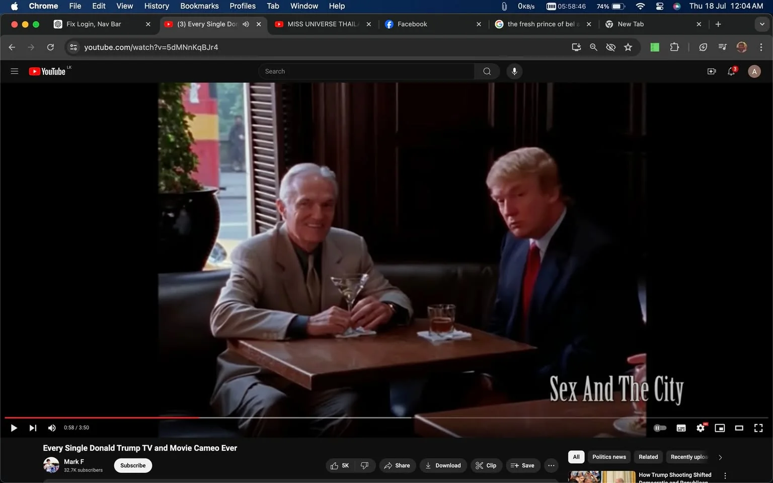 The screenshot shows a scene from a video titled "Every Single Donald Trump TV and Movie Cameo Ever," posted by the YouTube channel Mark F. The scene features Donald Trump sitting at a table in a dimly lit restaurant, accompanied by another man in a beige suit who is holding a martini glass. Donald Trump is dressed in a dark suit with a white shirt and red tie, appearing attentive and engaged. The setting is elegant, with wooden paneling, shuttered windows, and a potted plant visible in the background. The text "Sex And The City" is shown on-screen, indicating the show from which this cameo is taken. The lighting is warm, creating a sophisticated and formal atmosphere, suitable for the context of a high-end dining establishment.