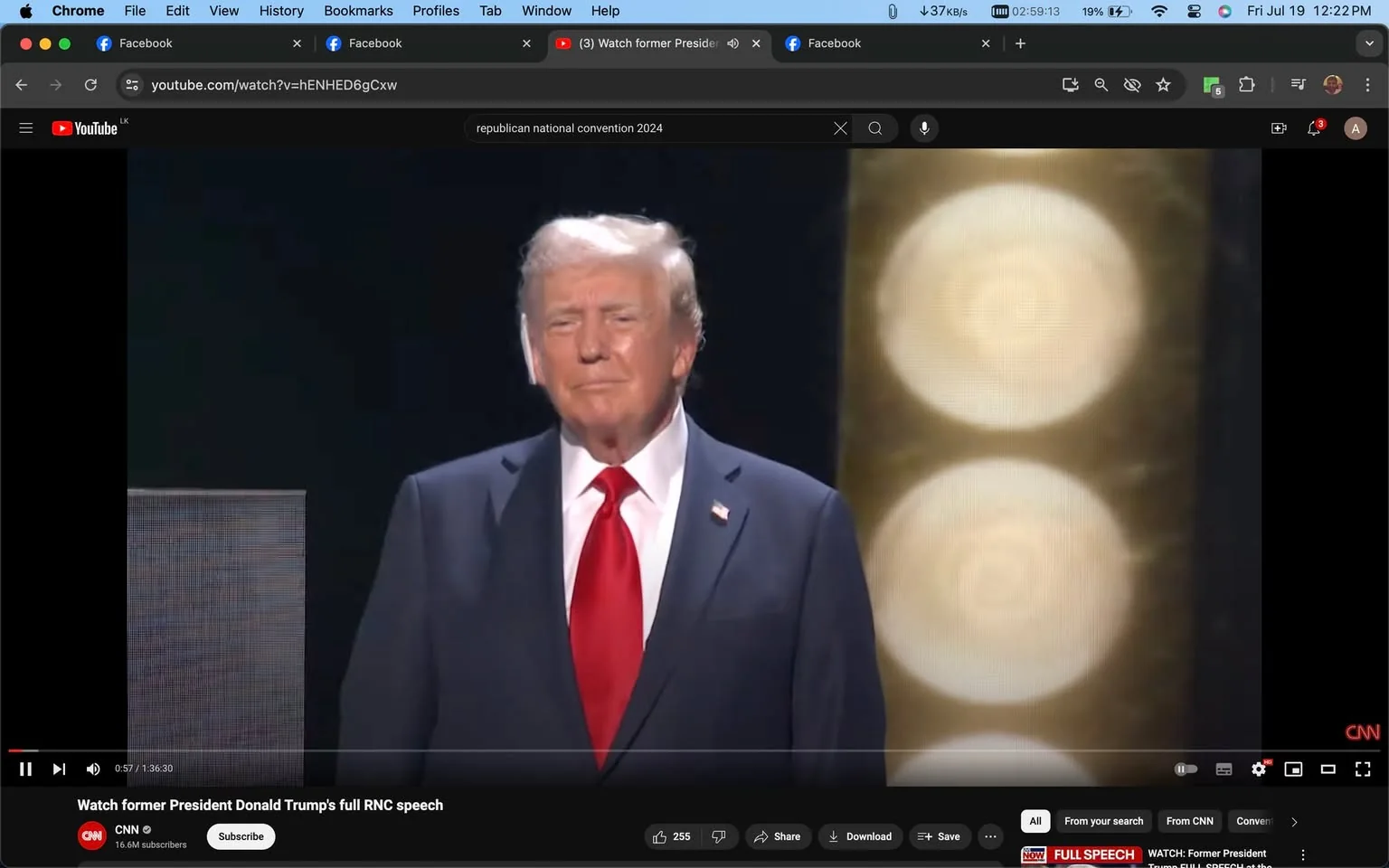 Donald Trump is featured prominently in this YouTube screenshot from CNN’s channel. He is standing on a stage, wearing a dark suit with a white shirt and a bright red tie, a classic attire choice for formal events. The backdrop is dark, highlighted by large, circular lights that add a dramatic flair to the setting. His expression is calm and composed, reflecting the serious nature of the occasion. This moment is part of a larger event, presumably a speech given at the Republican National Convention (RNC) in 2024. The YouTube video is titled "Watch former President Donald Trump's full RNC speech," indicating that viewers can watch the complete address. The interface shows typical YouTube features like the play button, video progress bar, and options to share or save the video. The presence of CNN’s logo in the bottom right corner underscores the network's coverage of the event.
- Title: "Watch former President Donald Trump's full RNC speech"
- Channel / profile: "CNN"
- Site / app: "YouTube"
