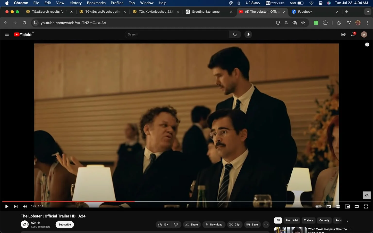 In this video frame from the official trailer for "The Lobster," distributed by A24 and titled "The Lobster | Official Trailer HD | A24" on YouTube, a formal dinner scene unfolds. The setting is an elegant dining area with a warm ambiance, characterized by soft, muted lighting and sophisticated decor. Three men, dressed in dark suits, are engaged in a conversation. One man seated on the left is animatedly talking to the man next to him, who listens with a neutral expression. Behind them, a standing man in a similar attire looks on, possibly contributing to the discussion. The table is adorned with a small lamp and drinks, adding to the upscale atmosphere. The background is softly blurred, with glimpses of other diners and floral arrangements. The overall tone of the scene is serious yet slightly tense, capturing the film's unique blend of drama and dark comedy.
- Title: "The Lobster | Official Trailer HD | A24"
- Channel / profile: "A24"
- Site / app: "YouTube"