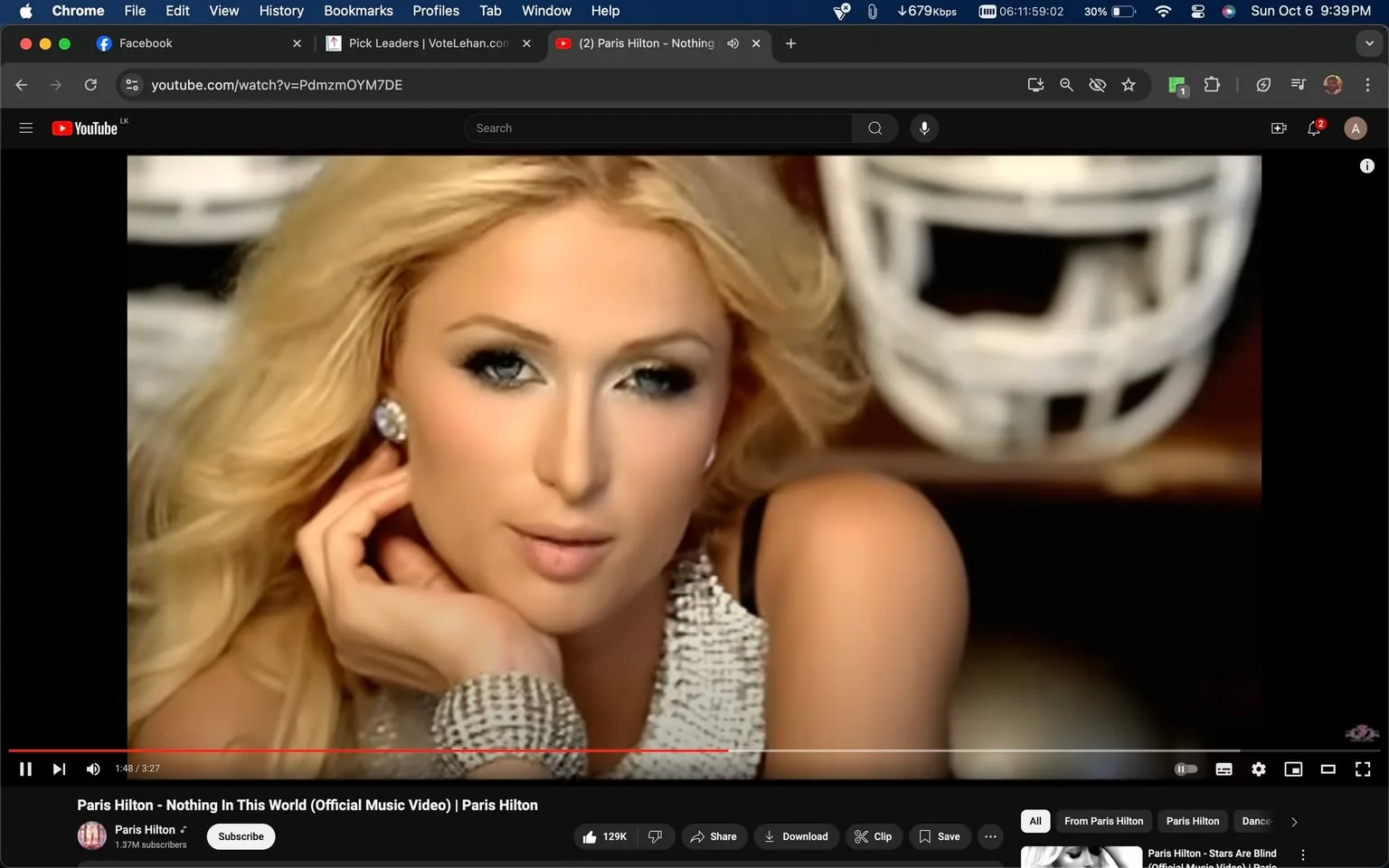Paris Hilton is prominently featured in this video frame from the music video "Nothing In This World." The scene captures her in a close-up shot, highlighting her glamorous and sophisticated look. She is adorned in sparkling jewelry, including a large, shimmering bracelet and matching earrings, which complement her elegant silver top. Her long, blonde hair is styled in loose waves, framing her face beautifully. The background is slightly blurred, with a white football helmet visible, adding a contrasting element to the otherwise glamorous setting. The lighting is soft, emphasizing the smoothness of her skin and the refined makeup look she is wearing, which includes a dramatic eye makeup style. This video is hosted on YouTube, under Paris Hilton's official channel, reflecting her persona as a celebrity and musician. Her expression is poised and confident, embodying the pop and fashion-forward style that she is known for. The overall mood of the frame is one of luxury and allure, typical of her music video aesthetics.
- Title: "Paris Hilton - Nothing In This World (Official Music Video) | Paris Hilton"
- Channel / profile: "Paris Hilton"
- Site / app: "YouTube"