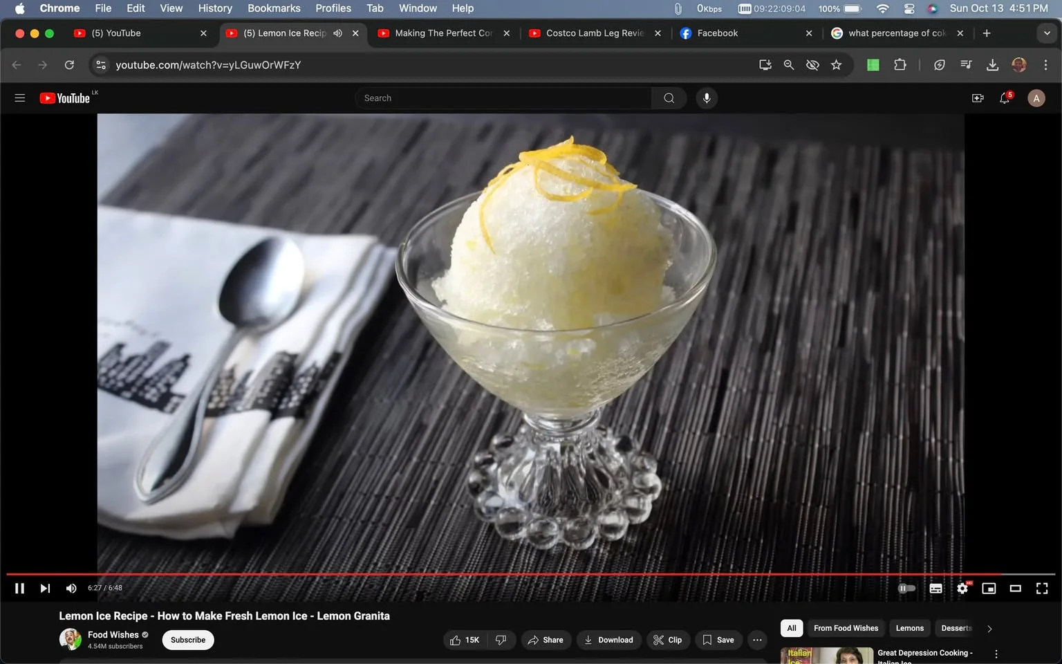 The image is a screenshot from a YouTube video titled "Lemon Ice Recipe - How to Make Fresh Lemon Ice - Lemon Granita," published by the channel Food Wishes. The frame shows a close-up of a dessert, specifically lemon granita, elegantly served in a vintage-style glass dish. The granita is adorned with thin strips of lemon zest, adding a touch of color to the otherwise icy white dessert. Beside the glass is a neatly folded napkin with an artistic print, accompanied by a spoon, suggesting readiness for consumption. The background consists of a textured, dark surface, which contrasts with the bright and refreshing appearance of the granita. This setting evokes a sophisticated and minimalist aesthetic, emphasizing the simplicity and elegance of the dish. The video belongs to the culinary category and focuses on a detailed recipe for making lemon ice, appealing to viewers interested in dessert preparation.
- Title: "Lemon Ice Recipe - How to Make Fresh Lemon Ice - Lemon Granita"
- Channel / profile: "Food Wishes"
- Site / app: "YouTube"