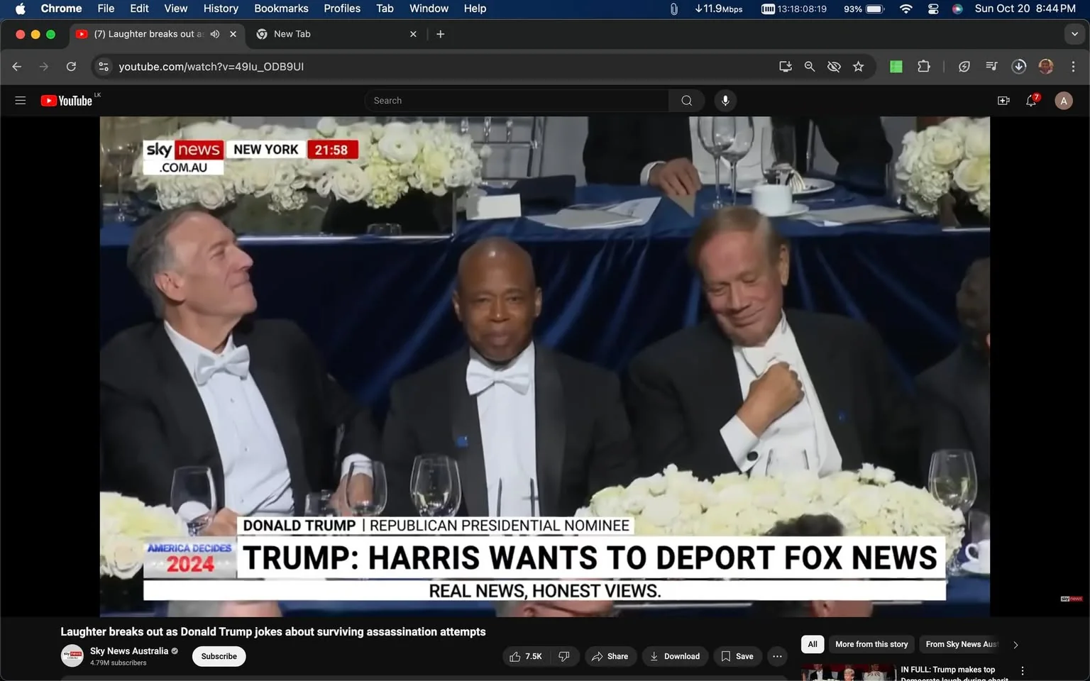 This image is a frame from a YouTube video titled "Laughter breaks out as Donald Trump jokes about surviving assassination attempts," featured on Sky News Australia's channel. The scene captures a formal event setting indoors, where three men in tuxedos are seated at a table adorned with white flowers and glassware. The man on the left is identified as Mike Pompeo, who is noted to have lost a significant amount of weight. They appear to be engaged in a light-hearted moment, possibly in reaction to a speech or remark, as suggested by their expressions and posture.
The video frame includes on-screen text indicating the location as New York and the timestamp as 21:58. The headline text reads "TRUMP: HARRIS WANTS TO DEPORT FOX NEWS," with the tagline "REAL NEWS, HONEST VIEWS" below it, emphasizing a political theme. The table setting is formal, with a navy blue tablecloth and elegant glassware, suggesting a high-profile event. The expressions of the individuals suggest amusement, aligning with the video’s theme of humor in a political context.
