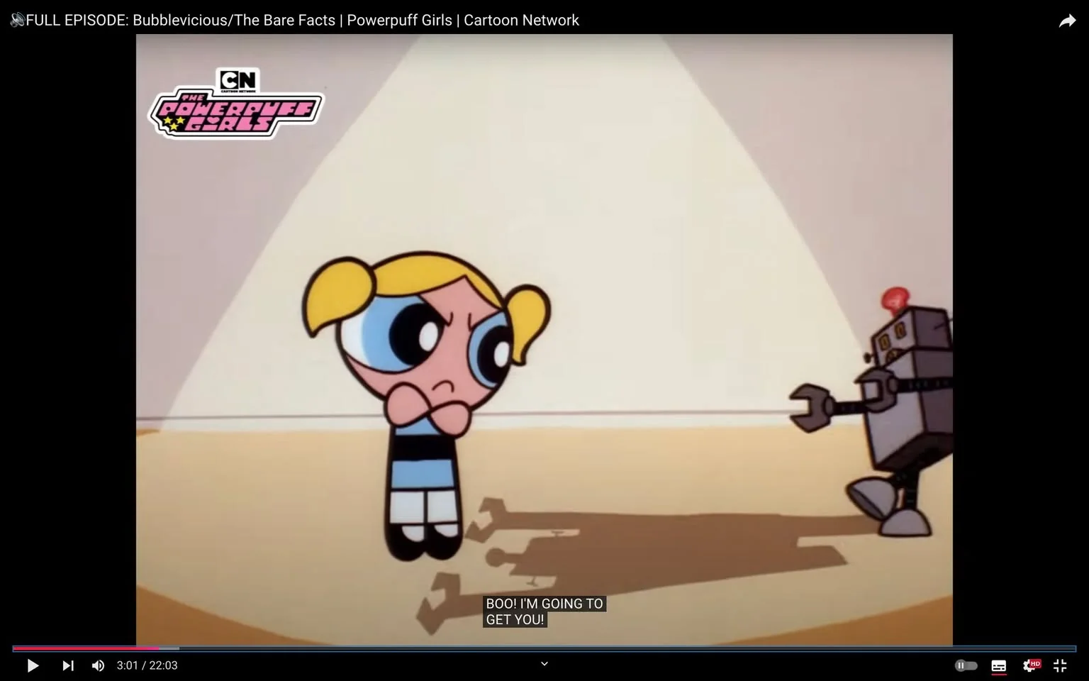 Bubbles from the Powerpuff Girls is featured in this animated scene. The frame shows her standing with a determined expression, her arms crossed in defiance. She has blonde pigtails and is wearing her signature blue dress with a black belt. A small robot is advancing towards her, with the text "BOO! I'M GOING TO GET YOU!" appearing as subtitles. The robot, with a metallic body and a red light on top, has a comedic and non-threatening appearance. The setting is a simple, indoor environment with a spotlight effect casting shadows on the floor, highlighting the confrontation between Bubbles and the robot. The scene is brightly lit and colorful, typical of the animation style used in the Powerpuff Girls series, which is known for its bold outlines and vibrant colors. The overall mood suggests a playful yet tense moment, reflecting the show's theme of lighthearted heroics. The episode is part of the Cartoon Network's offerings, as indicated by the branding visible in the frame.
- Title: "FULL EPISODE: Bubblevicious/The Bare Facts | Powerpuff Girls | Cartoon Network"
- Channel / profile: "Cartoon Network"
- Site / app: "YouTube"
- Captions / subtitles: "BOO! I'M GOING TO GET YOU!"