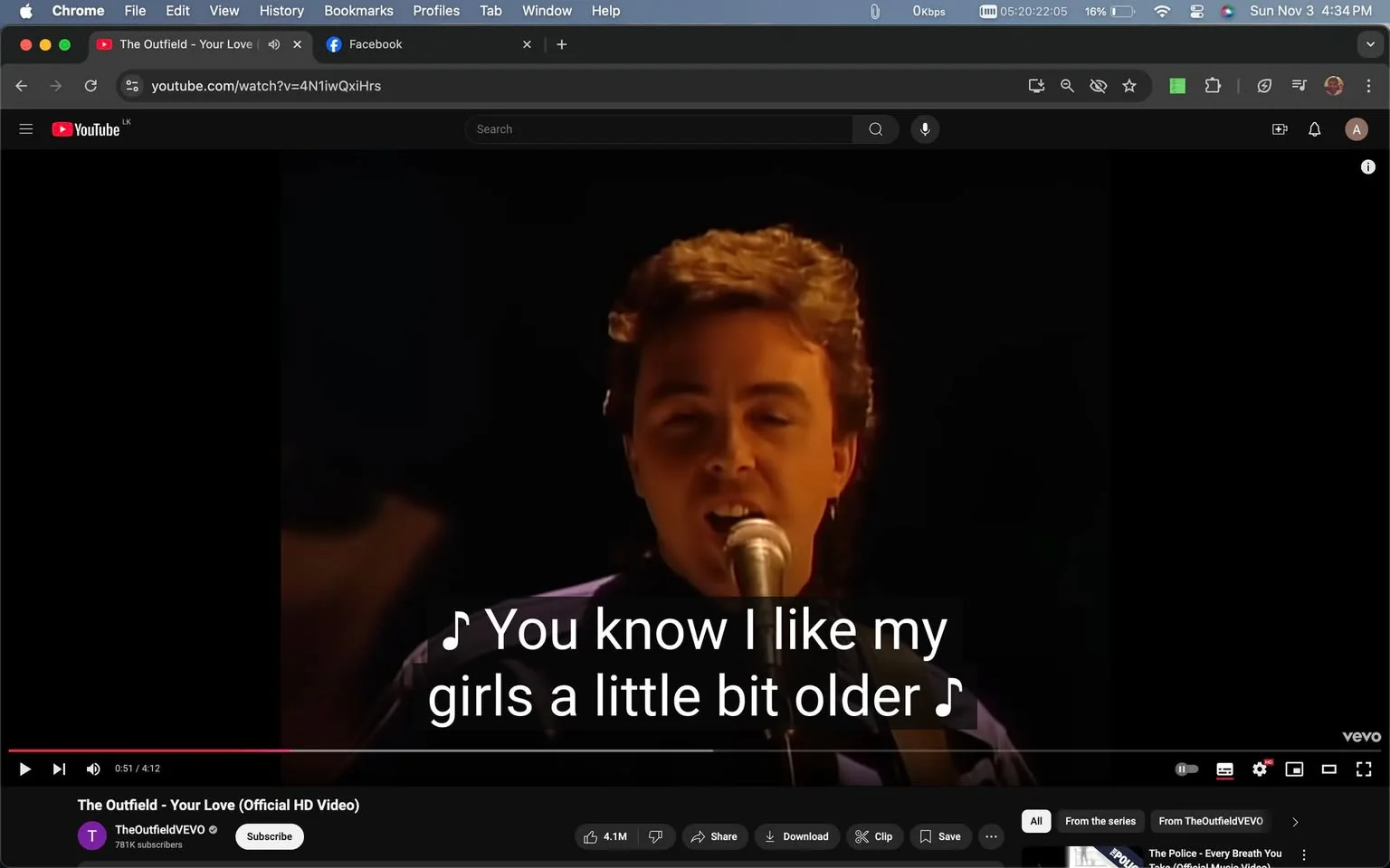 The image is a video frame from the official HD music video for the song "Your Love" by The Outfield. The scene is set in a dimly lit indoor environment, focusing on a member of the band singing into a microphone. The performer is positioned centrally, capturing the audience's attention with a direct gaze towards the camera. The lighting is soft, highlighting the musician's facial features while keeping the background out of focus. The singer's expression is one of engagement and focus, typical of a live performance setting.
The interface shows the video playing on YouTube, evident from the recognizable layout and controls, including the play/pause button and the video progress bar at the bottom. The channel "TheOutfieldVEVO" is visible, indicating the official music video channel. The video has garnered significant attention, as shown by the high number of likes and views. Captions are enabled, displaying the lyrics, "You know I like my girls a little bit older," a line from the song. The overall mood conveys a nostalgic feel, fitting for a classic 1980s music video.