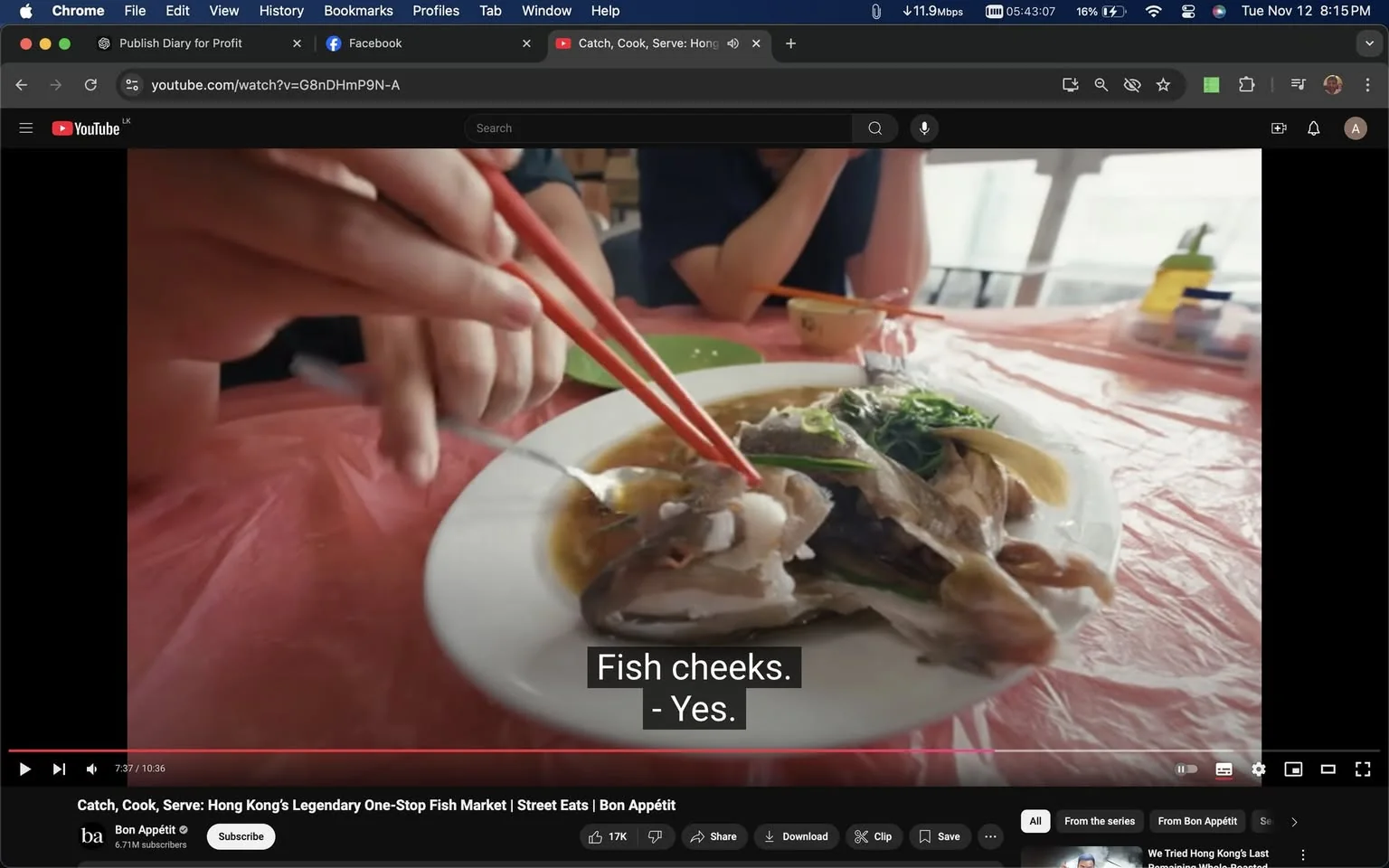 The image is a frame from a YouTube video titled "Catch, Cook, Serve: Hong Kong's Legendary One-Stop Fish Market | Street Eats | Bon Appétit," published by the Bon Appétit channel. The scene is set indoors at a dining table covered with a pink tablecloth. A hand is seen using red chopsticks to pick up a piece of fish from a plate, while another hand holds a spoon. The dish appears to consist of fish, possibly steamed, garnished with greens. The mood is casual and focused on dining and food exploration.
The subtitles at the bottom of the frame read, "Fish cheeks." "- Yes." This exchange suggests a discussion about the specific part of the fish being eaten, highlighting an aspect of culinary interest or delicacy. The setting suggests a cultural exploration of local cuisine, typical of the "Street Eats" series. The video seems to be a culinary tour or food review in Hong Kong, emphasizing authentic and traditional dishes.