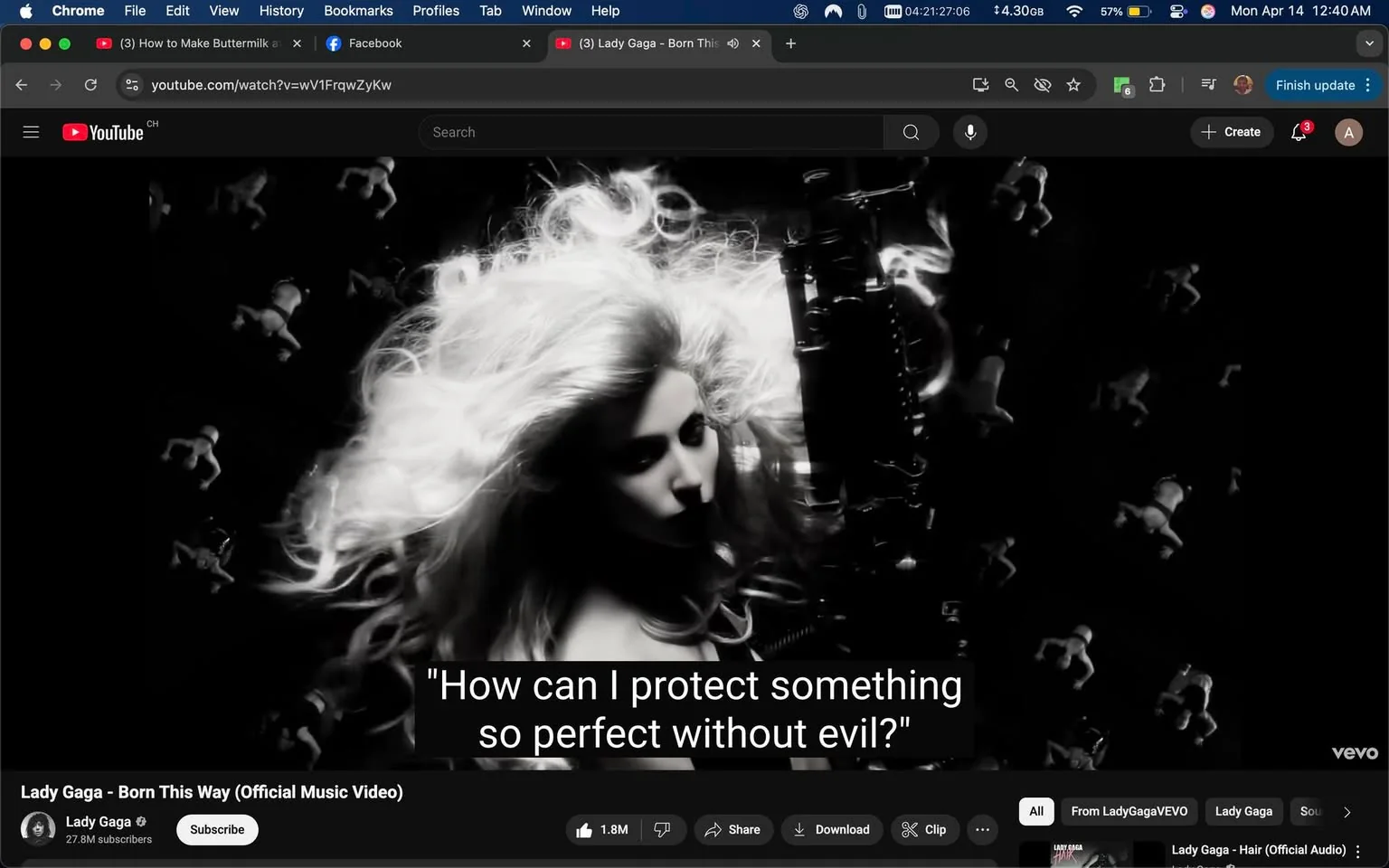 The image displays a scene from a music video featuring a woman with long, flowing hair styled in loose waves. The hair appears voluminous and is highlighted against a dark background. The woman is positioned slightly to the side, with her head tilted down, creating a dramatic effect. She has a serious expression on her face, and her gaze is directed away from the camera.

In the background, there are faint, ghostly images of small figures that resemble dancing or moving silhouettes, adding a surreal quality to the scene. The overall color scheme is monochromatic, primarily in shades of black and white, which enhances the dramatic atmosphere.

At the bottom of the image, there is a caption that reads: "How can I protect something so perfect without evil?" This text is displayed in a bold, white font against a black background, making it easily readable.

The interface of the video player is visible at the bottom, indicating that this is a YouTube video. The title of the video is "Lady Gaga - Born This Way (Official Music Video)," and it shows that the channel is Lady Gaga, with a subscriber count of 27.8 million. There are also options to subscribe, share, download, and clip the video.

The time displayed in the top right corner indicates that it is 12:40 AM on April 14. The browser window shows additional tabs, including one for a recipe video and a Facebook tab. The overall layout suggests a casual viewing environment, likely on a personal computer.