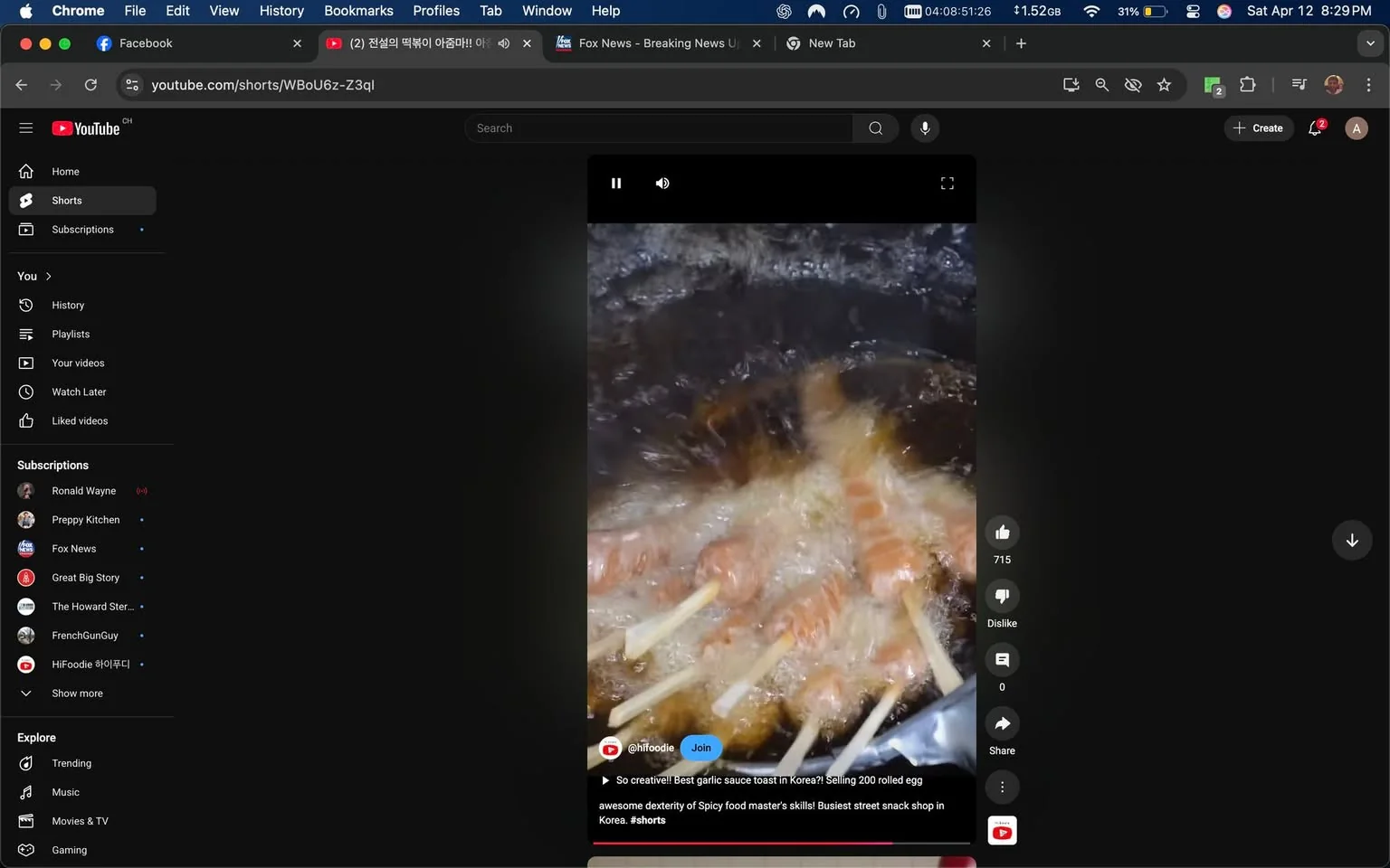 The image displays a YouTube Shorts video interface set against a dark background. The video shows food being fried in a pot of bubbling oil. Several skewers, likely containing rolled eggs or similar items, are submerged in the oil, creating a lively splash effect. The food appears golden brown, indicating that it is being cooked.

On the left side of the screen, there is a sidebar featuring various sections such as "Home," "Shorts," "Subscriptions," and "Explore." Under "Subscriptions," several channel names are listed, including "Ronald Wayne," "Preppy Kitchen," "Fox News," and others. Each channel name is followed by a dot, indicating a subscription status.

At the bottom of the video, there is a caption that reads: "So creative!! Best garlic sauce toast in Korea?! Selling 200 rolled egg awesome dexterity of Spicy food master's skills! Busiest street snack shop in Korea. #shorts." This text is in white font against a dark background, making it easily readable.

The video has a play button overlay, indicating that it is currently paused. To the right of the video, there are interaction buttons showing the number of likes (715) and a dislike button (0). There is also a "Share" option visible.

Overall, the setting appears to be a street food environment, likely in Korea, given the context of the caption. The focus is on the cooking process, showcasing the skill involved in preparing the food. The video is framed in a vertical format typical of short video content.