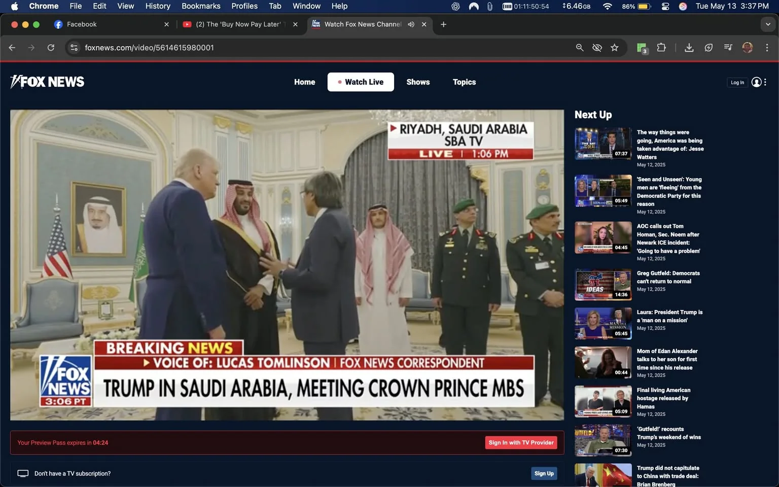 The image depicts a meeting taking place in a formal setting, likely a government or diplomatic venue in Riyadh, Saudi Arabia. In the foreground, there are three men engaged in conversation. 

1. **People**:
   - **Man on the left**: He has light-colored hair and is wearing a dark suit with a white shirt and a blue tie. He appears to be facing the man in the center and is gesturing with his right hand.
   - **Man in the center**: He is dressed in traditional Saudi attire, which includes a white thobe and a black bisht (a cloak) with gold trim. He has a red and white checkered ghutrah (headscarf) secured with an agal (black cord). He is smiling and appears to be engaged in conversation with the man on the left.
   - **Man on the right**: He is wearing a dark suit and has glasses. He is also gesturing with his hands, possibly explaining something to the man in the center.
   - In the background, there are two men in military uniforms, both wearing green berets and adorned with various insignia. They stand at attention, observing the interaction.

2. **Setting**:
   - The background features ornate decor, including a large, framed portrait of a man (not identifiable) on the wall, possibly a Saudi leader. The walls are decorated with intricate patterns, and there are heavy drapes in a dark color hanging from the windows.
   - There are two flags visible: the American flag on the left and the Saudi flag on the right, indicating the diplomatic nature of the meeting.

3. **Text**:
   - At the bottom of the image, there is a banner with the text "BREAKING NEWS" and "TRUMP IN SAUDI ARABIA, MEETING CROWN PRINCE MBS," indicating that this is a news broadcast segment. The logo for Fox News is also visible in the corner.

4. **Overall Context**:
   - The image captures a moment of diplomacy, likely during a significant meeting between U.S. and Saudi officials. The formal attire and the presence of military personnel suggest a serious and respectful atmosphere.

This description includes all observable details without speculation or interpretation.
