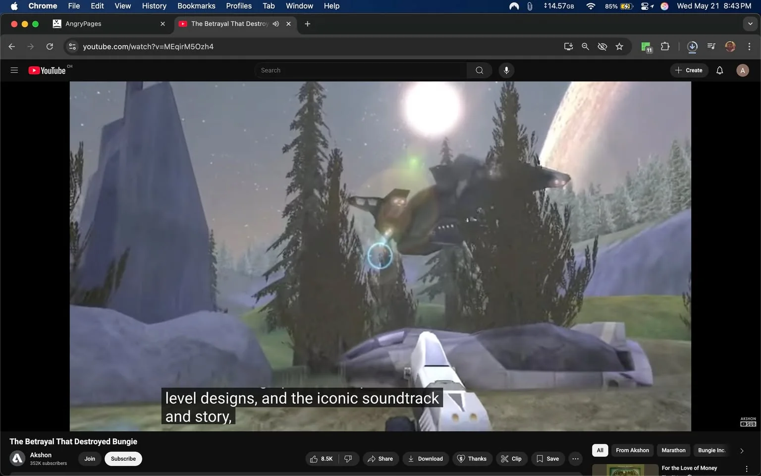 The image depicts a scene from a video game, likely related to the "Halo" franchise, given the visual elements present. 

In the foreground, there is a white futuristic weapon, resembling a pistol, positioned on a rocky surface. The weapon has a sleek design with a prominent barrel and a grip that suggests advanced technology. 

To the right of the weapon, there are large, gray rocks and a few green trees, indicating a natural environment. The trees are tall and slender, with a dark green color, suggesting a forested area. 

In the background, a large, dark spacecraft is visible, hovering above the landscape. The ship has a somewhat angular design with visible lights and details that suggest it is a military or sci-fi vehicle. The ship appears to be emitting a blue light, possibly indicating some form of technology or energy. 

The sky is a gradient of colors, transitioning from light to dark, with a large celestial body, possibly a planet, visible in the background. The presence of stars and a bright light source, likely a sun, adds to the otherworldly atmosphere of the scene.

At the bottom of the image, there are subtitles that read: "level designs, and the iconic soundtrack and story," indicating that this is likely a video discussing aspects of the game. 

The video player interface is visible at the bottom, showing options to share, download, and subscribe, along with the channel name "Akshon" and the subscriber count of 352K. The title of the video is "The Betrayal That Destroyed Bungie," suggesting a focus on the history or impact of the game developer Bungie.

Overall, the image captures a moment from a video game with a focus on sci-fi elements, technology, and a natural landscape, accompanied by textual information related to the video content.
