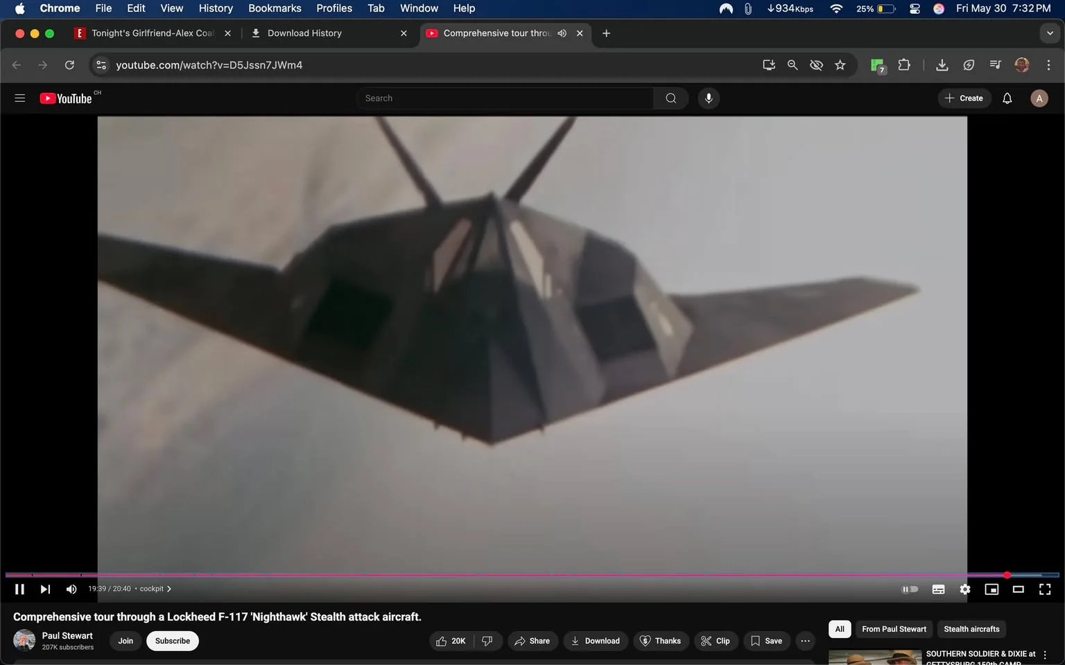 The image depicts a Lockheed F-117 Nighthawk stealth attack aircraft, prominently shown from a low angle as it appears to be flying. The aircraft features a distinctive angular design with a dark, matte finish that enhances its stealth capabilities. The wings are sharply pointed and extend outward, giving it a triangular silhouette. The body of the aircraft has several flat surfaces and sharp edges, characteristic of stealth technology, which minimizes radar visibility.

In the background, there are soft, cloudy skies, suggesting the aircraft is in flight at a high altitude. The lighting appears to be natural, possibly indicating daytime, with a slight overcast that diffuses the sunlight.

There are no visible people, text, or logos in the image. The focus remains solely on the aircraft, which is the central subject. The overall composition emphasizes the aircraft's unique design and stealth features without any distractions from other objects or elements in the scene. 

The video player interface at the bottom shows that this image is part of a YouTube video titled "Comprehensive tour through a Lockheed F-117 'Nighthawk' Stealth attack aircraft," hosted by a user named Paul Stewart, who has 207K subscribers. The video is currently at the timestamp of 19:39 out of a total of 20:40 minutes. The interface includes options to like, share, download, and comment, but no additional text or images are present in the surrounding area.