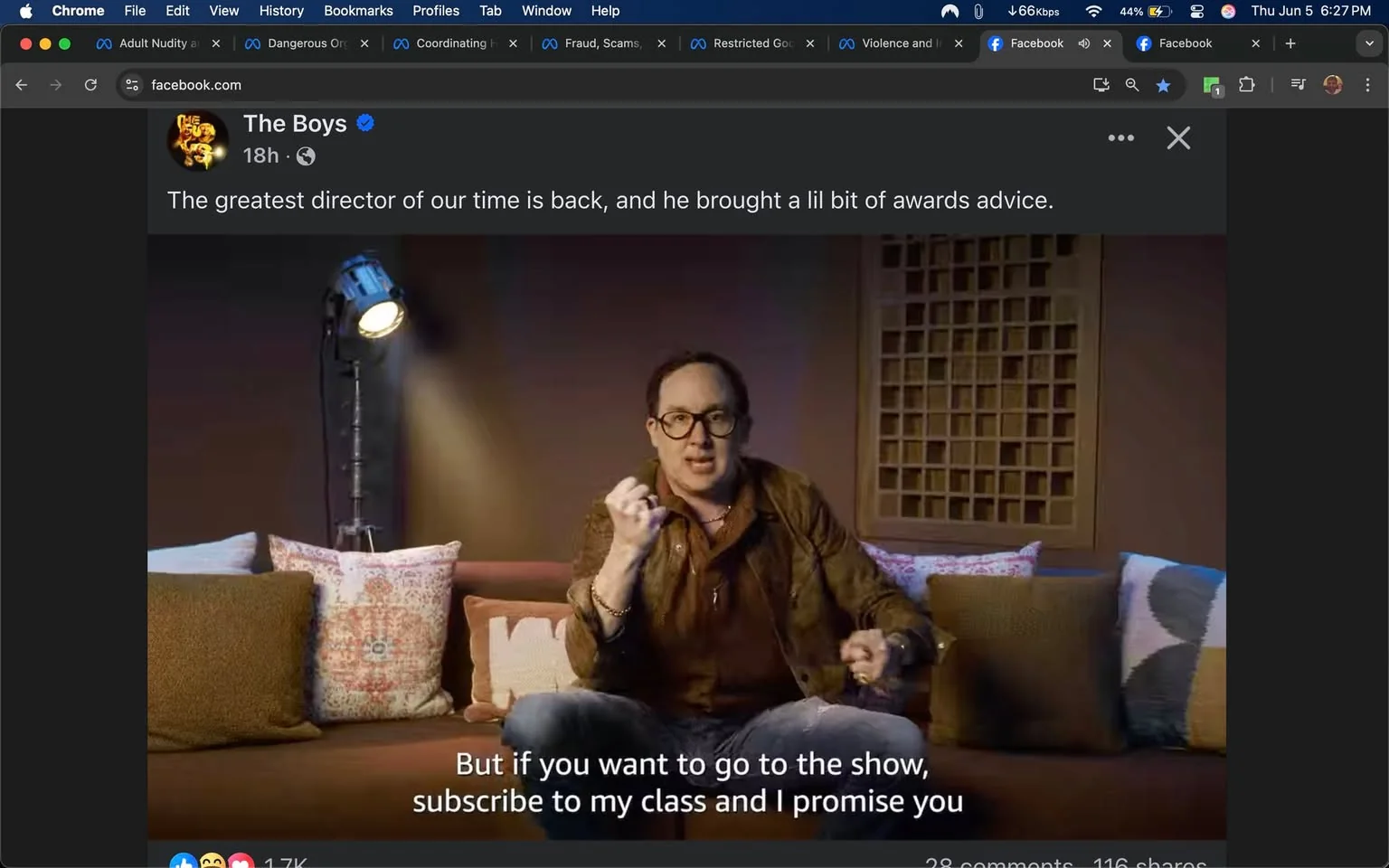 The image features a man sitting on a couch in a well-lit indoor setting. He is wearing a brown leather jacket over a dark shirt, with blue jeans. The man has short, dark hair and is wearing glasses. He appears animated, using his hands to emphasize his points while speaking. His facial expression is engaged and expressive.

The couch is adorned with several decorative pillows in various colors and patterns. There are two prominent pillows: one has a geometric design in shades of red and white, while another is a solid brown. The couch itself is a muted color, possibly beige or light brown.

To the left of the man, there is a spotlight on a stand, casting light on him. The background features a wooden panel with a grid-like design, adding texture to the setting. The overall ambiance is cozy and informal, suggesting a casual talk or presentation.

At the bottom of the image, there is readable text that states: "But if you want to go to the show, subscribe to my class and I promise you." Above this text, there is a logo for "The Boys," which appears to be a stylized representation, possibly indicating a connection to a show or series.

The post is from a Facebook page, as indicated by the interface elements visible at the top of the image, including icons for reactions, comments, and shares. The post was made 18 hours ago, as noted in the timestamp. The engagement metrics show 1.7K reactions, 28 comments, and 116 shares. 

Overall, the image captures a moment of a presentation or promotional content related to "The Boys," with a focus on the speaker's advice regarding a class or show.