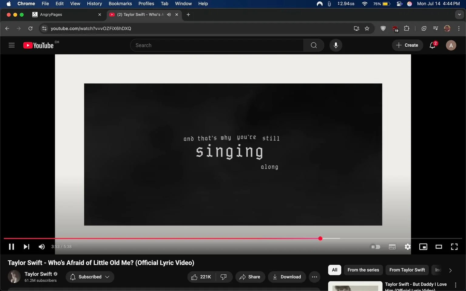 The image displays a still from a YouTube lyric video for Taylor Swift's song "Who's Afraid of Little Old Me?" The background is predominantly black with a smoky texture, creating a dramatic atmosphere. Centered in the frame, the text reads: "and that's why you're still singing along," with the word "singing" emphasized in a larger, bold font. The text is white, contrasting sharply against the dark background, enhancing readability.

At the bottom, the video player interface is visible, showing the playhead at 3:53 of a 5:38 duration. Below the video, the channel name "Taylor Swift" is displayed, along with a subscriber count of 61.2 million. There are options to share or download the video, indicating engagement features typical of YouTube. The overall tone is reflective and nostalgic, suggesting themes of connection and shared experiences through music. The absence of any people or facial expressions focuses attention solely on the lyrical content and visual presentation.