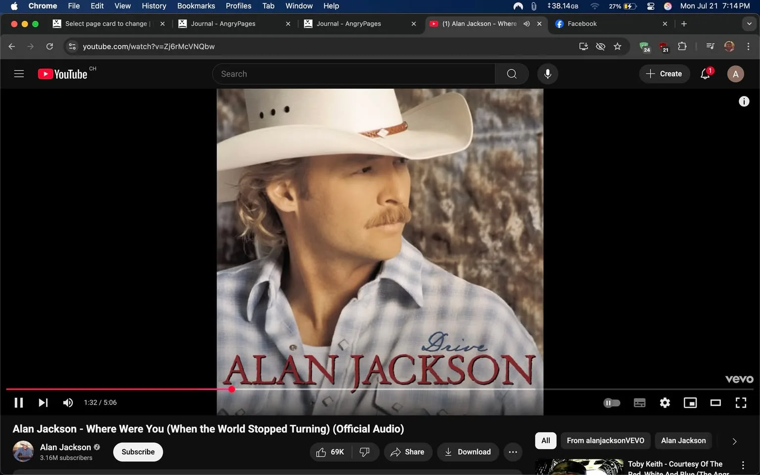 The image features a YouTube video player displaying the official audio for the song "Where Were You (When the World Stopped Turning)" by Alan Jackson. The video showcases a prominent image of Alan Jackson, who is depicted in a thoughtful pose, gazing slightly to the side. He has a distinctive look characterized by his light-colored cowboy hat, which has a wide brim and a decorative band. His hair is wavy and light, complementing his fair complexion. A neatly groomed mustache adds to his classic country singer appearance.

He is wearing a light blue plaid shirt that has a relaxed fit, suggesting a casual yet stylish vibe typical of country music aesthetics. The background is softly blurred, featuring earthy tones that evoke a rustic feel, enhancing the overall country theme of the image. The text overlay includes his name, "ALAN JACKSON," prominently displayed in a bold, red font that stands out against the softer colors of the image. The word "Drive" is also included, possibly indicating the album title or theme.

The video player interface is visible at the bottom, showing the play bar with a timestamp indicating that the video is 1 minute and 32 seconds into a total length of 5 minutes and 6 seconds. Below the video, there are options to subscribe, share, and download, along with a view count of 69,000 likes, suggesting that the song is popular and well-received by listeners.

The overall tone of the image is nostalgic and reflective, resonating with the themes of the song, which deals with significant moments and emotions tied to historical events. The combination of Alan Jackson's iconic look and the song's poignant message creates a strong connection to the country music genre, evoking feelings of sentimentality and introspection. The image captures not just a moment in time but also the essence of a musical legacy that speaks to many listeners.