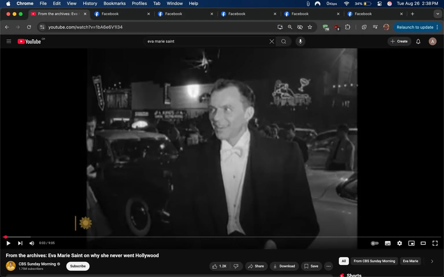 1) Rich description (8–12 sentences): This is a desktop screenshot of a YouTube video page in Chrome, showing black-and-white archival footage playing in the main player. The hint identifies the man in the video as Frank Sinatra, and he is shown in a tuxedo with a white bow tie and dark jacket, smiling and turned slightly to his right. He appears to be standing outdoors at night, surrounded by parked cars and a crowd in the background. The footage has a grainy, vintage newsreel look, with bright highlights and deep shadows. In the lower-left corner of the video frame there is a small CBS Sunday Morning-style sun logo watermark. The YouTube interface is visible around the player, including the search bar with the query “eva marie saint.” The video title below the player reads “From the archives: Eva Marie Saint on why she never went Hollywood.” The channel shown is CBS Sunday Morning, with the channel name and subscribe button visible. The playback bar indicates the video is at 0:03 of 9:05, and standard controls such as play, volume, settings, and fullscreen are visible. The browser tab row and address bar are also visible at the top, reinforcing that this is a screen capture rather than the original video.
2) On-screen text block:
- Title: "From the archives: Eva Marie Saint on why she never went Hollywood"
- Channel / profile: "CBS Sunday Morning"
- Site / app: "YouTube"
- Captions / subtitles: ""